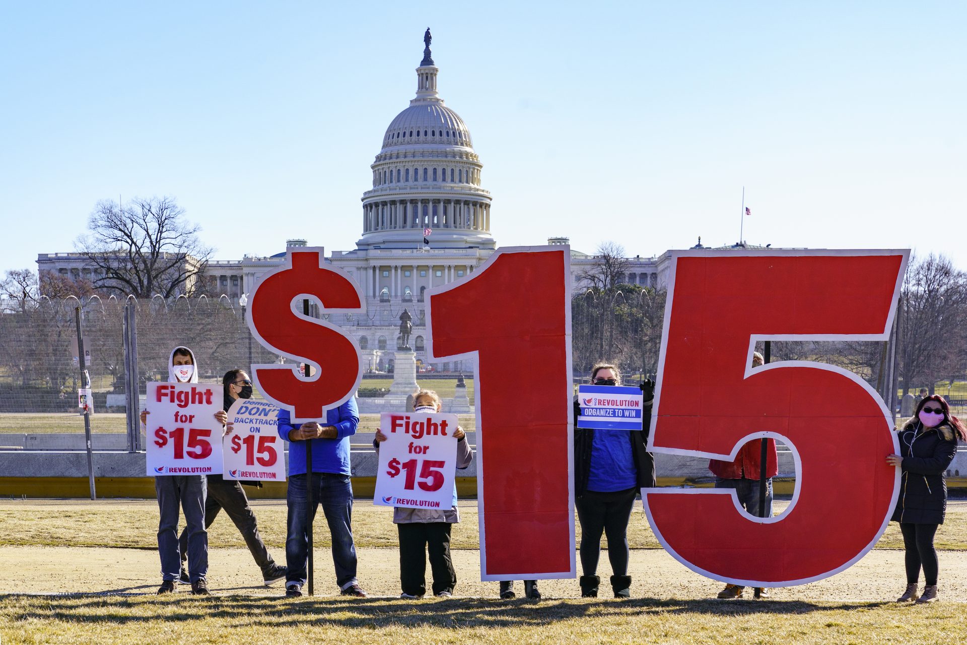 Activists appeal for a $15 minimum wage near the Capitol in Washington, Thursday, Feb. 25, 2021.