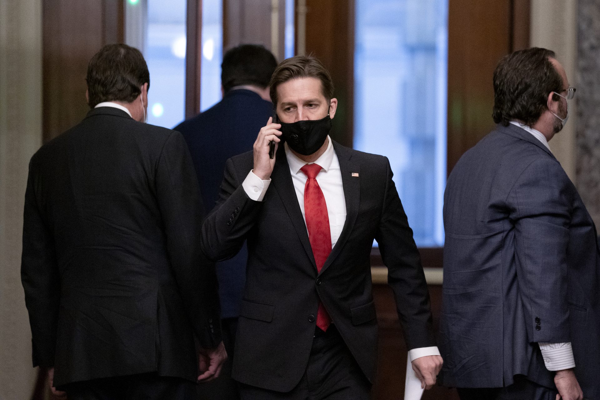 Sen. Ben Sasse, R-Neb., center, walks on Capitol Hill on the fifth day of the second impeachment trial of former President Donald Trump, Saturday, Feb. 13, 2021 at the Capitol in Washington.