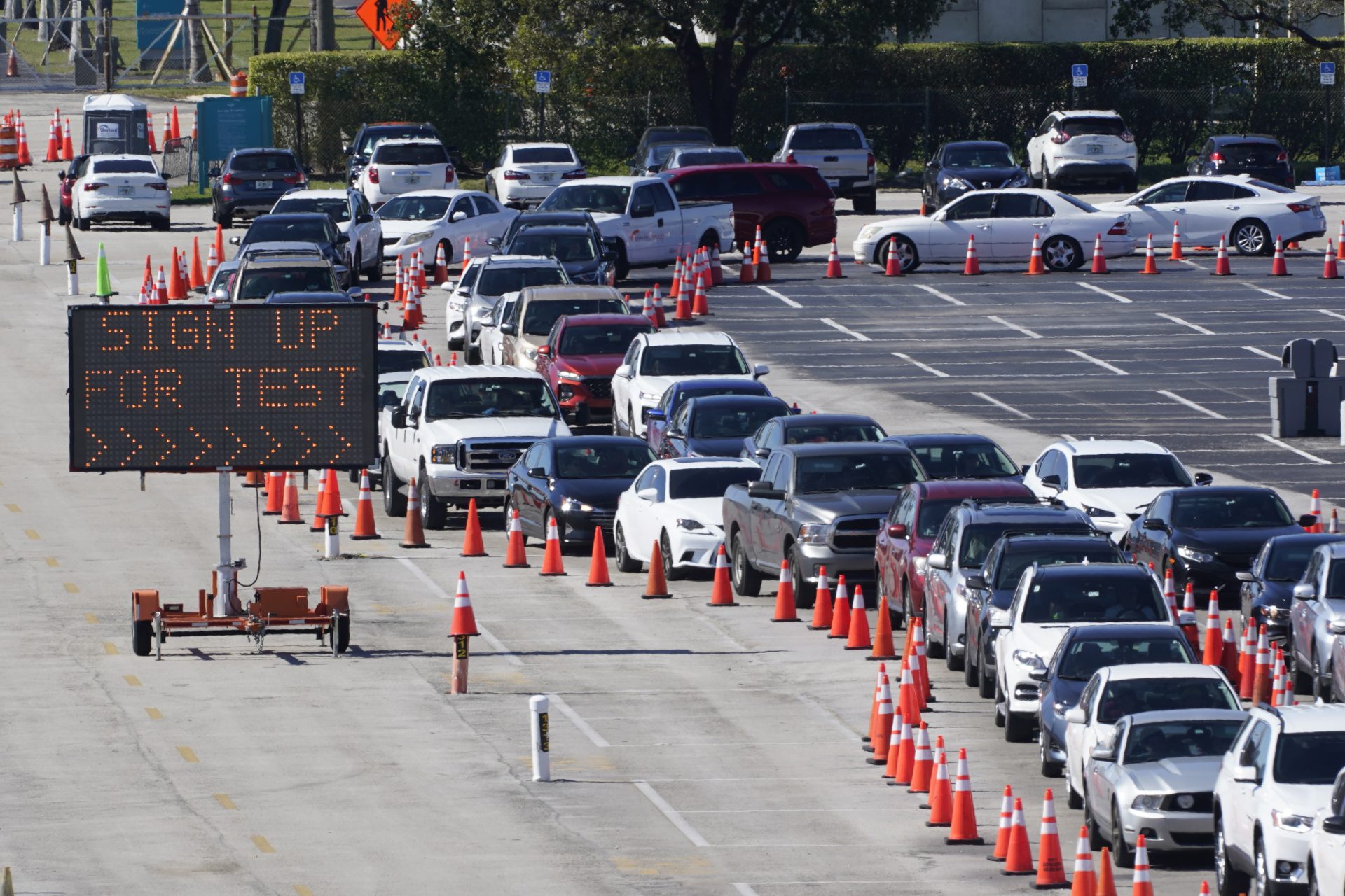 In this Jan. 5, 2021, file photo, cars line up for COVID-19 testing outside Hard Rock Stadium in Miami Gardens, Fla. Coronavirus hospitalizations are falling across the United States, but deaths have remained stubbornly high.