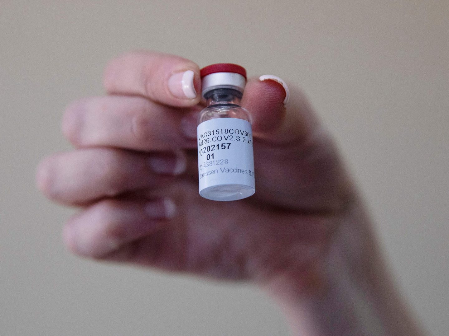 A health care worker holds a vial of the Johnson & Johnson COVID-19 vaccine at Klerksdorp Hospital in Klerksdorp, South Africa, on Feb. 18.