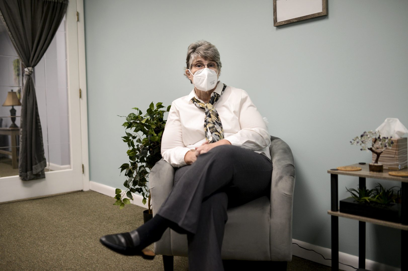 Jodee Pineau-Chaisson sits in her office in Springfield, Mass. on January 12, 2021. Pineau-Chaisson, a social worker, contracted the coronavirus last May and continues to have symptoms even months after testing negative for the virus.