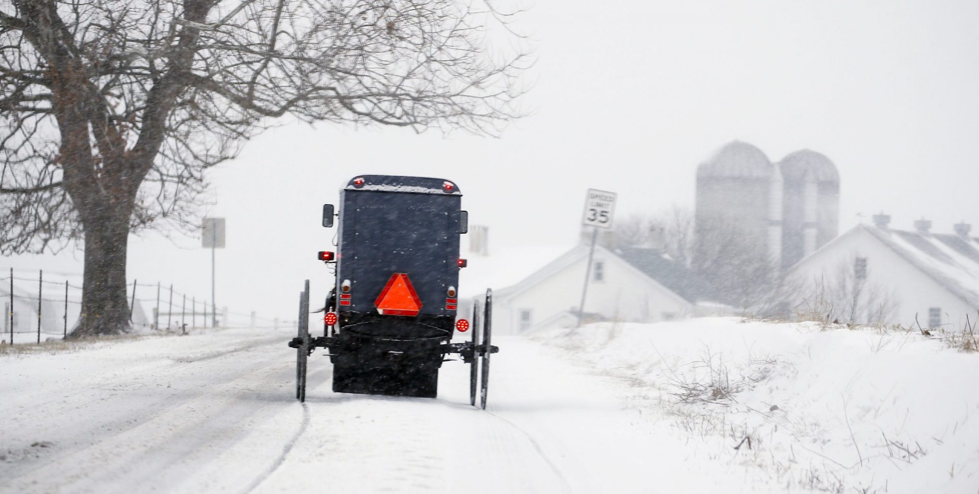 An Amish buggy traverses the backroads of Lancaster County, Pa., Sunday, Jan. 31, 2021, as the Northeast braces for a storm that could dump well over a foot of snow in many areas and create blizzard-like conditions.