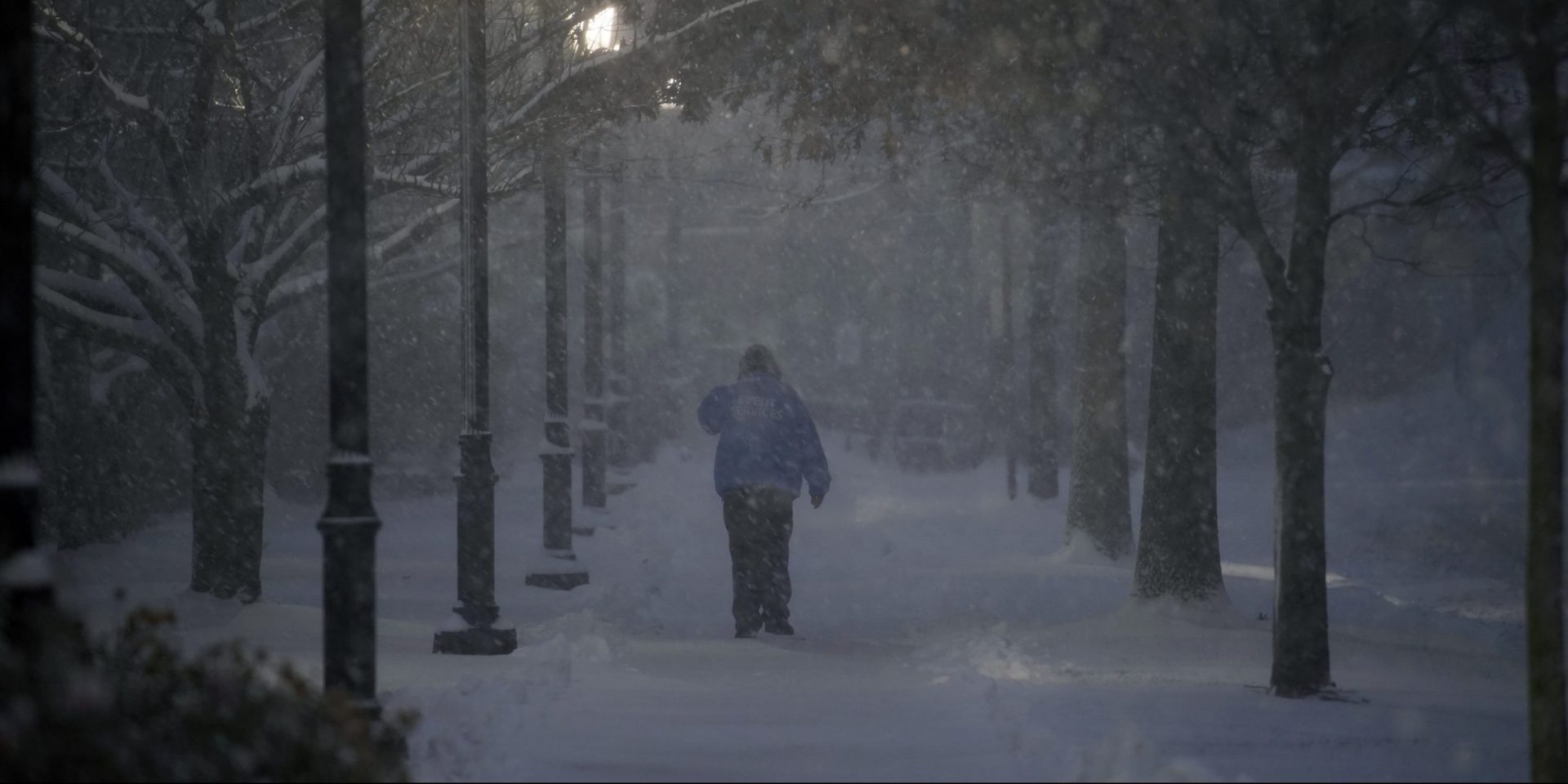 A man walks through the Villanova University campus during a snow storm, Wednesday, Dec. 16, 2020, in Villanova, Pa.