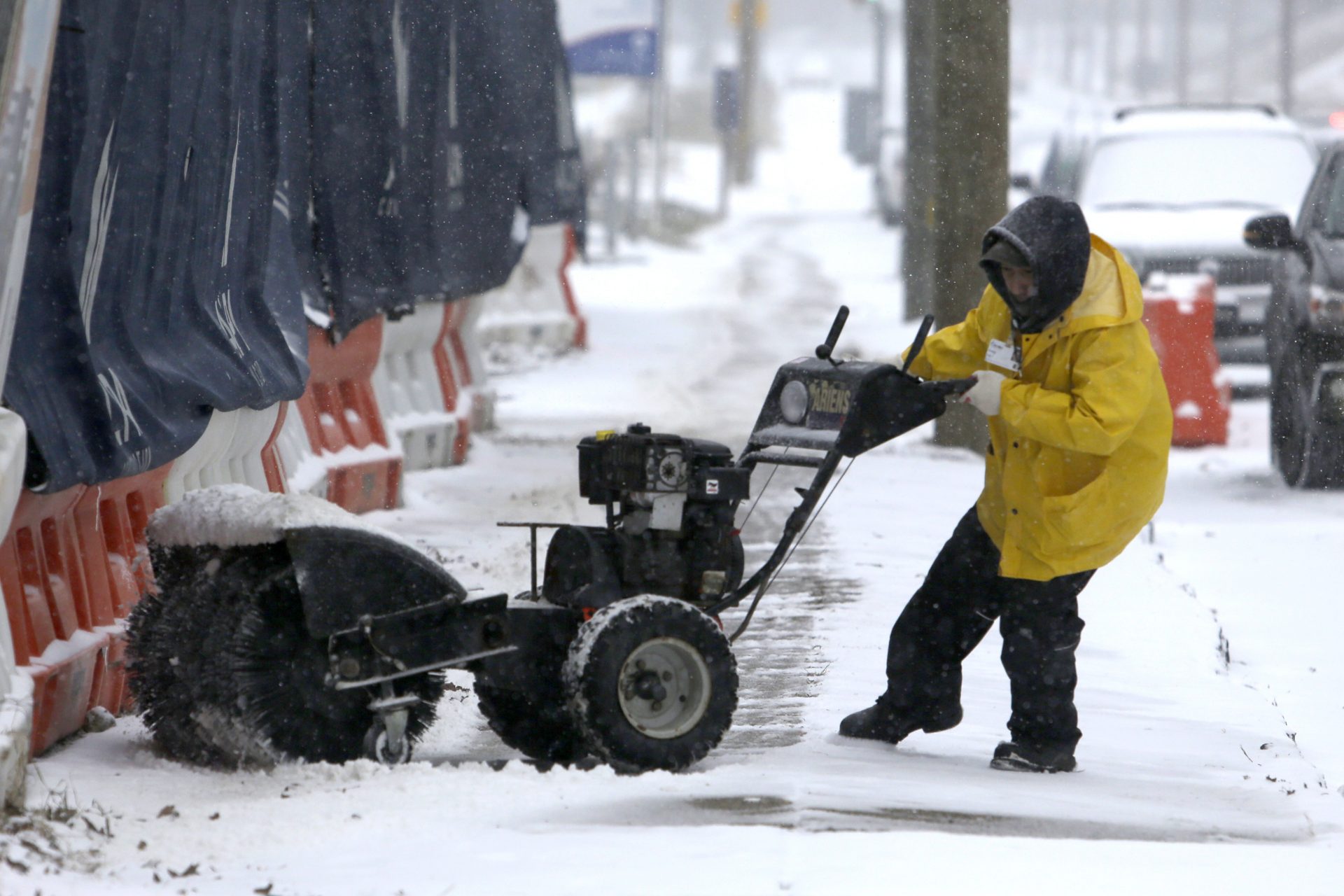 A man works to turn his snow-clearing machine Sunday Jan. 31, 2021 in Philadelphia.