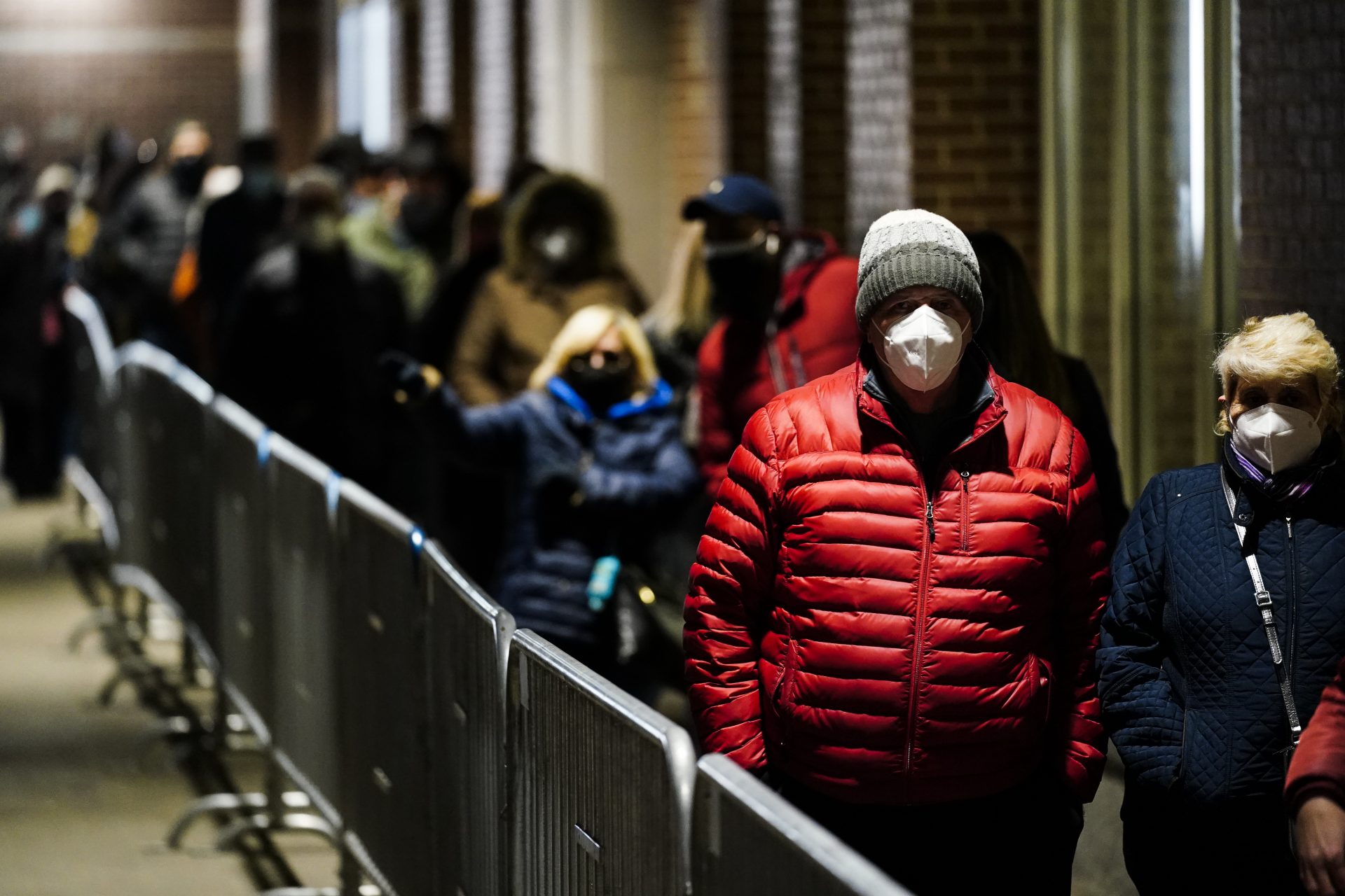 People wait in line at a FEMA Community Vaccination Center at the Pennsylvania Convention Center in Philadelphia, Wednesday, March 3, 2021.