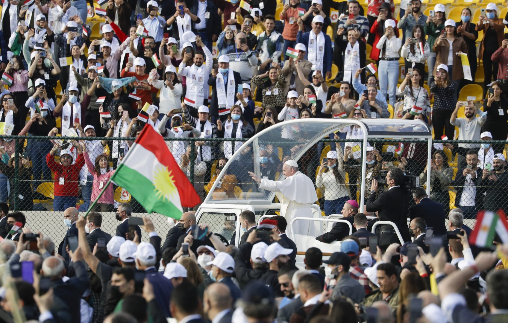 Pope Francis arrives on the popemobile to celebrate mass at the Franso Hariri Stadium in Irbil, Kurdistan Region of Iraq, Sunday, March 7, 2021. The Vatican and the pope have frequently insisted on the need to preserve Iraq's ancient Christian communities and create the security, economic and social conditions for those who have left to return.(AP Photo/Andrew Medichini)