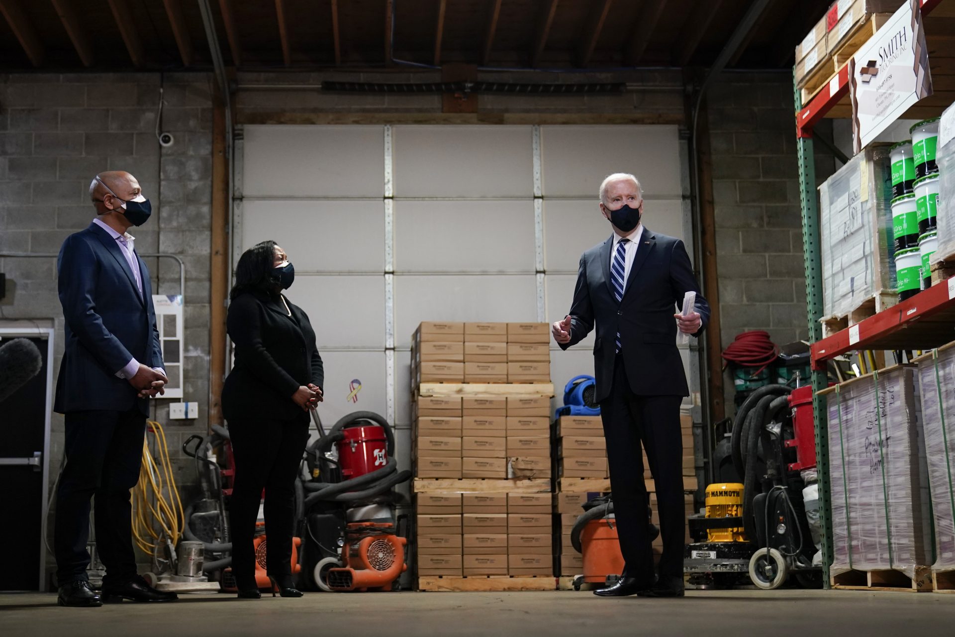 President Joe Biden speaks with owners Kristin Smith and James Smith as he visits Smith Flooring in Chester, Pa., Tuesday, March 16, 2021.