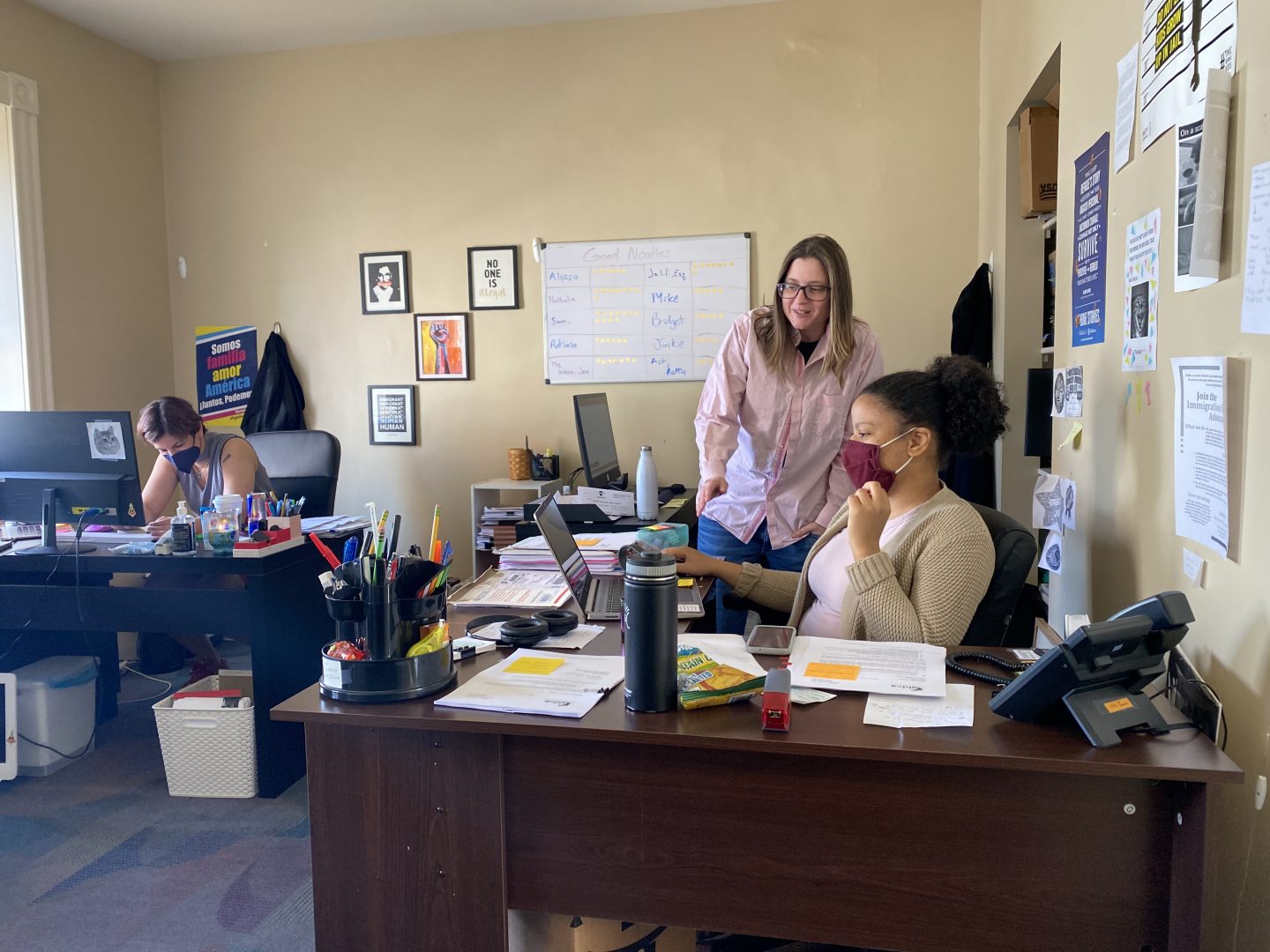 ALDEA executive director Bridget Cambria reviews work of communications and intake assistant Nathalia Cruz in ALDEA's downtown Reading office.