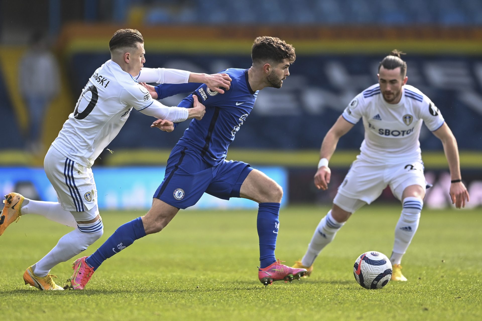 Chelsea's Christian Pulisic, right, challenges for the ball with Leeds United's Ezgjan Alioski during the English Premier League soccer match between Leeds United and Chelsea at Elland Road stadium, in Leeds, England, Saturday, March 13, 2021.