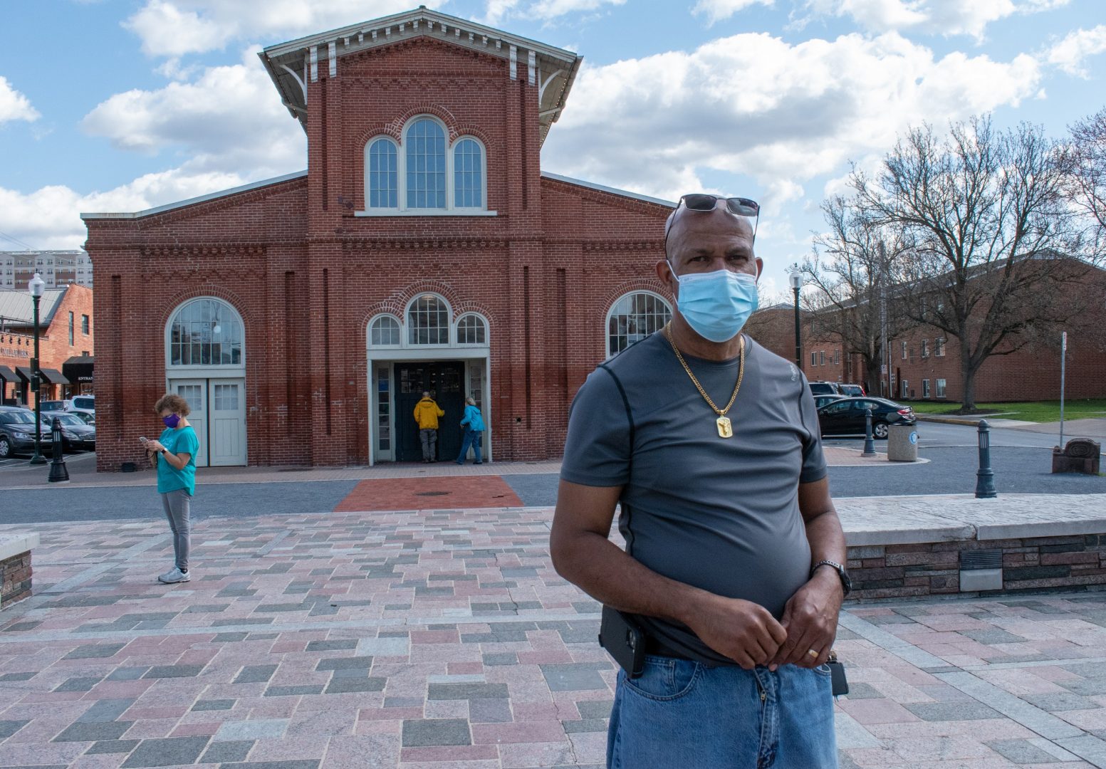 Dil Tulloch stands for a portrait outside Broad Street Market Friday, March 26, 2021. Tulloch had COVID-19 last summer. Though he has been vaccinated, he remains cautious about the risks of the virus.