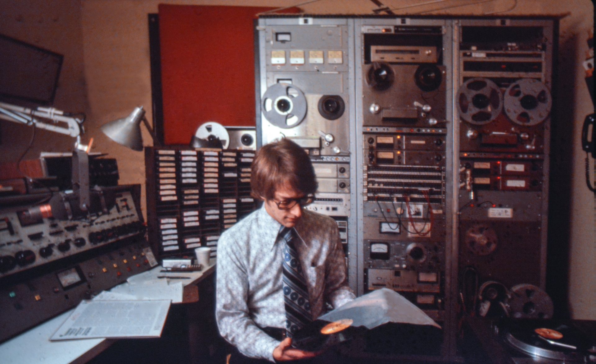 David Ginder, WITF Music Director from 1978 – 1985, selects the next classical tune to air on WITF FM, from the Hershey Community Building circa 1979.