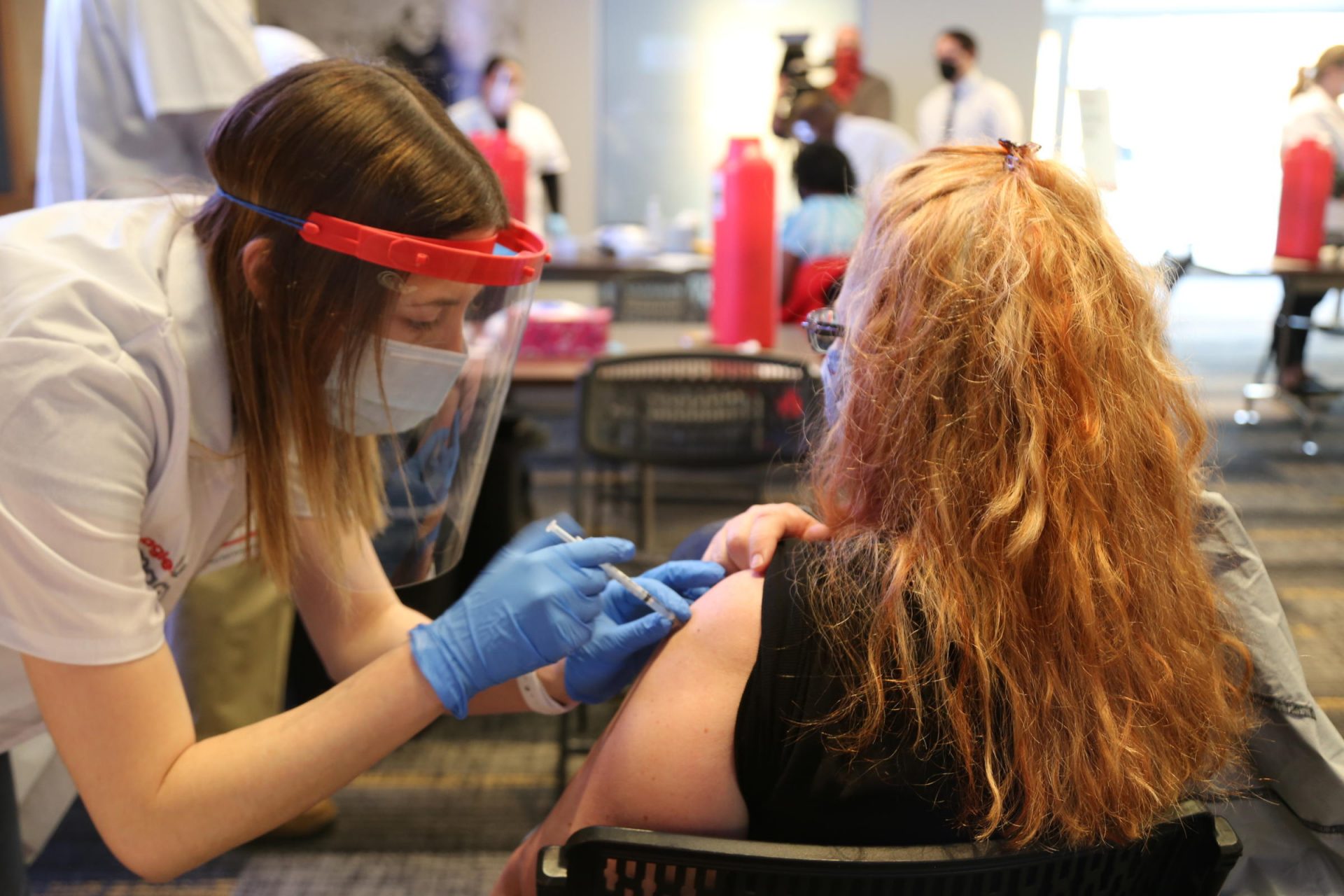 An educator receives a COVID-19 vaccine at a clinic in Heinz Field on Thursday, March 11, 2021.