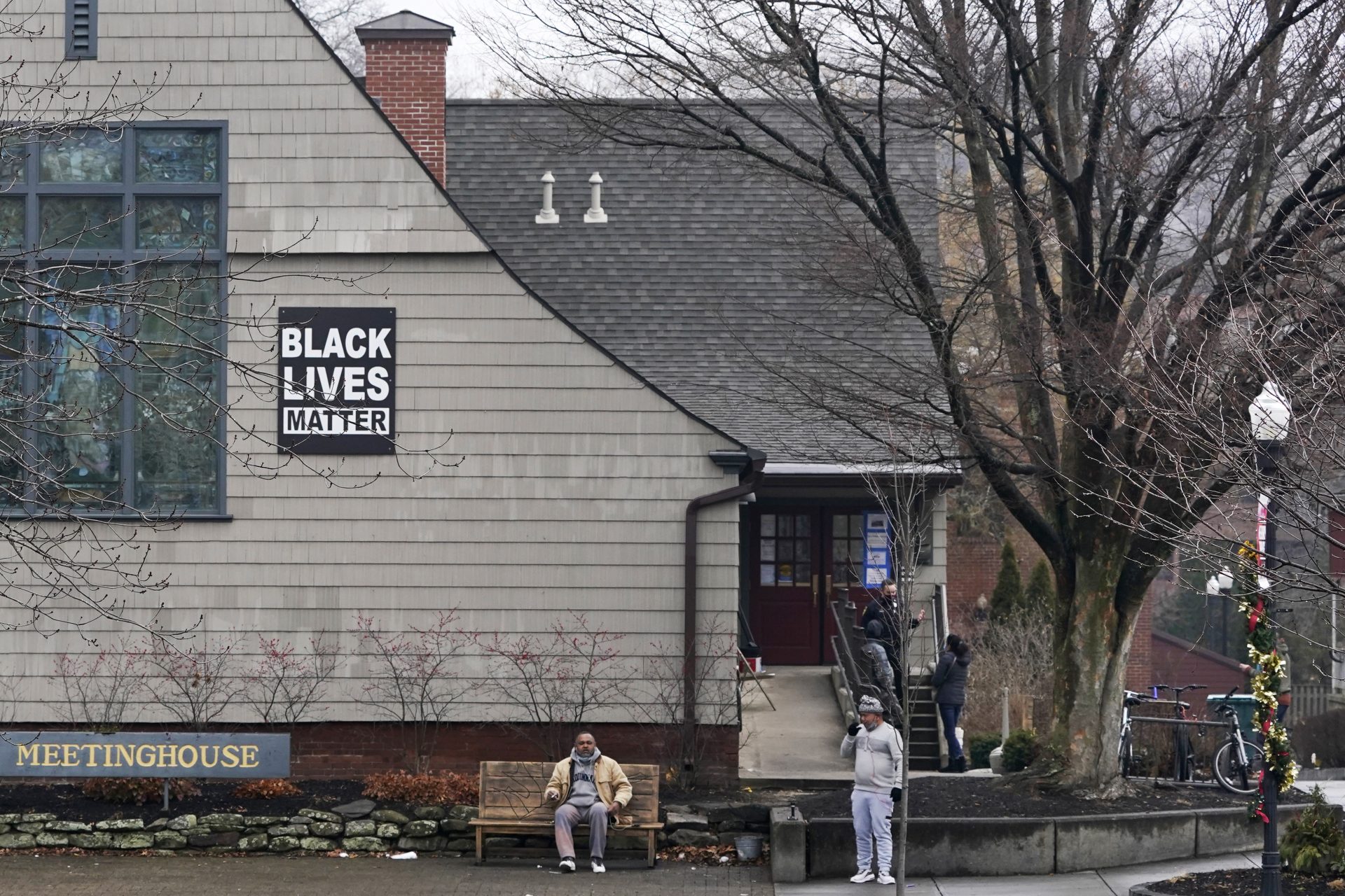 A "Black Lives Matter" sign hangs from the Universalist Meetinghouse, Friday, Jan. 15, 2021, in Amherst, Mass.