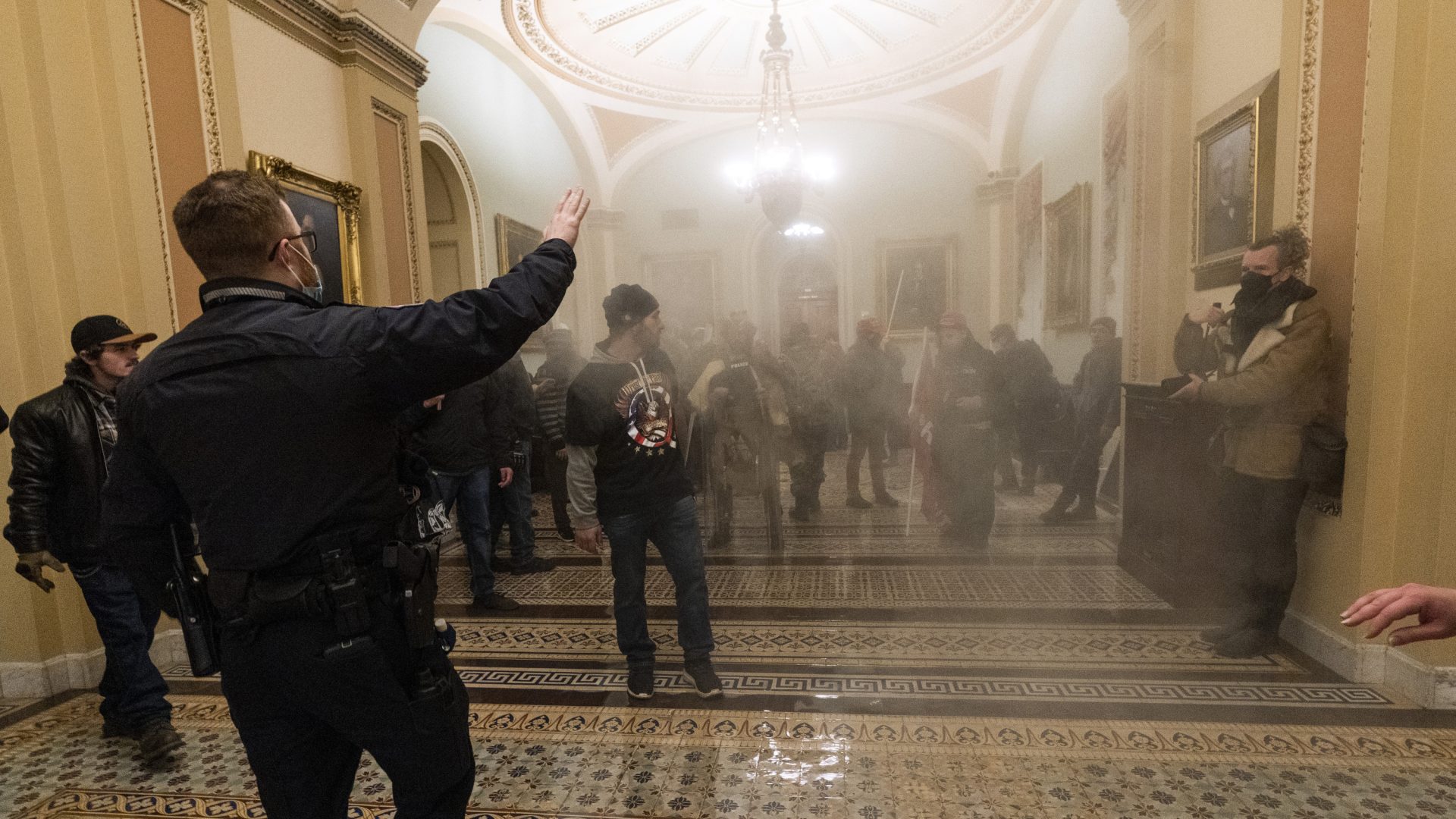 FILE PHOTO: Smoke fills the walkway outside the Senate chamber as U.S. Capitol Police confront rioters inside the Capitol on Jan. 6, 2021.