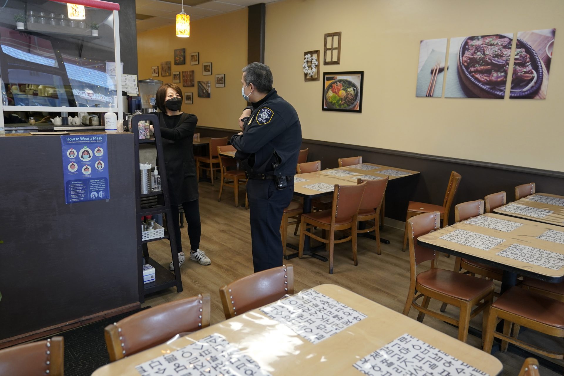 Steve Hirjak, right, a Seattle Assistant Chief of Police and head of SPD's Collaborative Policing Bureau, talks with Ji Young Shim, left, owner of the Seoul Tofu House and Korean BBQ restaurant in Seattle's Chinatown-International District Thursday, March 18, 2021, during a foot patrol.