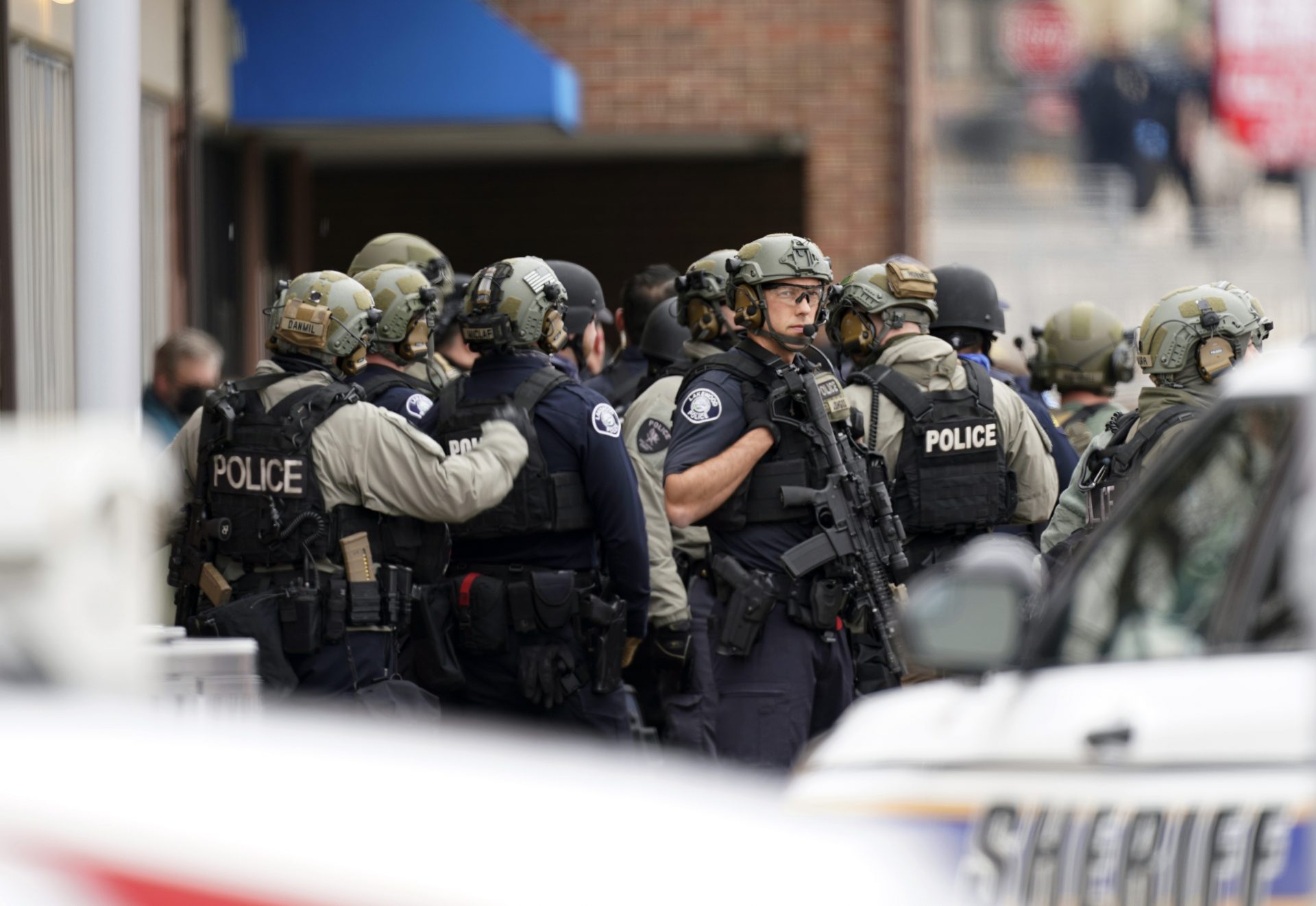 Police stand outside a King Soopers grocery store where authorities say multiple people have been killed in a shooting, Monday, March 22, 2021, in Boulder, Colo.