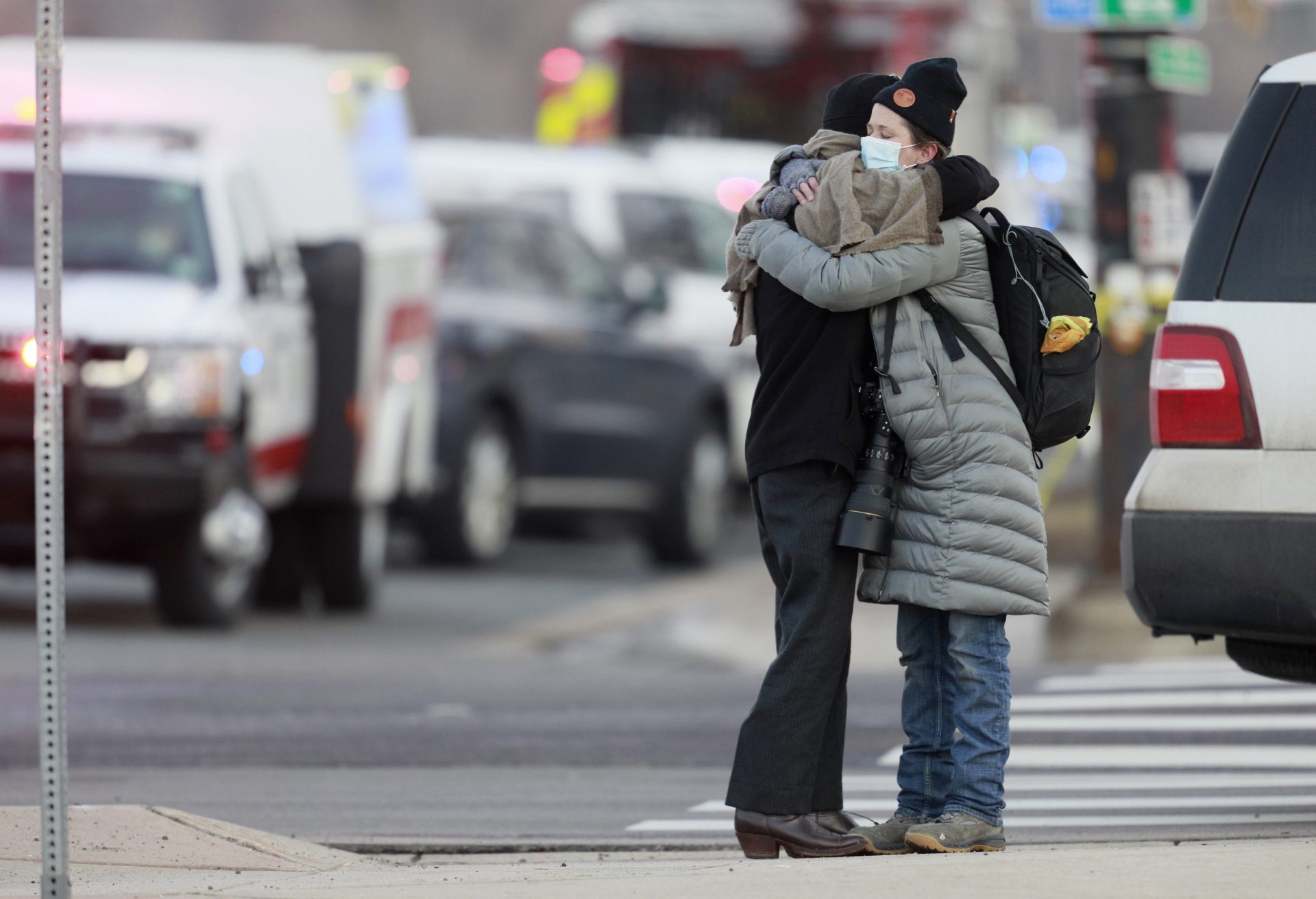 Women hug on the corner of Broadway and Table Mesa Drive near a King Soopers grocery store where a shooting took place, Monday, March 22, 2021, in Boulder, Colo.