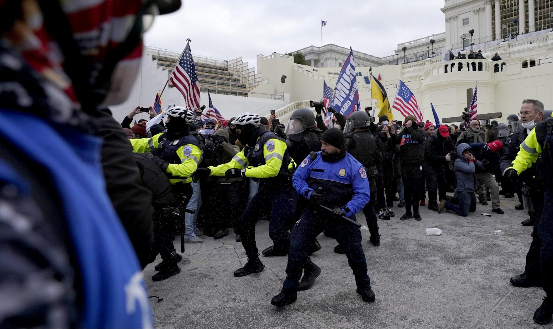 Police officers try to push back President Donald Trump supporters trying to break through a police barrier, Wednesday, Jan. 6, 2021, at the Capitol in Washington. The incident happened as Congress prepared to affirm President-elect Joe Biden's victory, with thousands of people gathered to show their support for President Donald Trump and his claims of election fraud. 