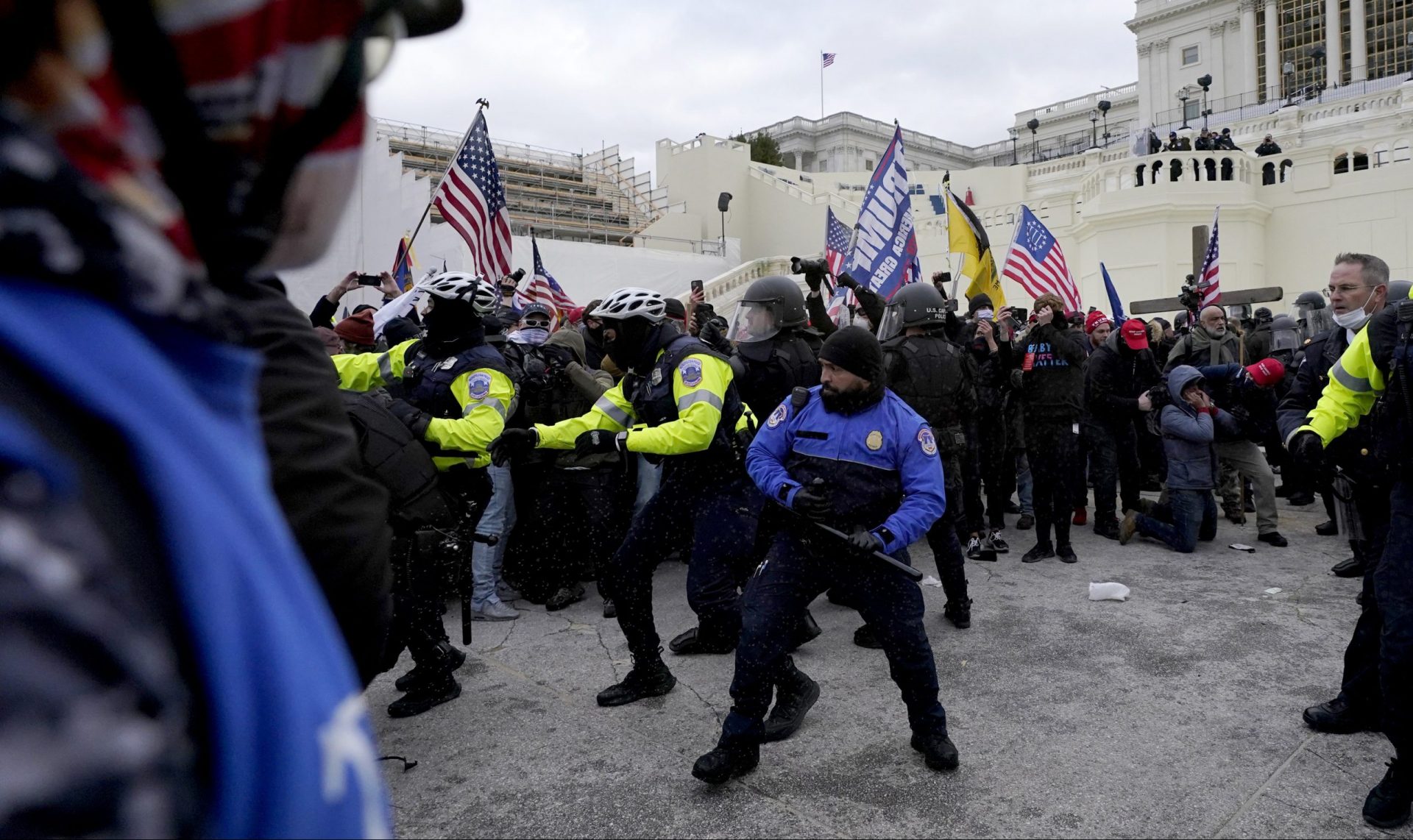 Police officers try to push back President Donald Trump supporters trying to break through a police barrier, Wednesday, Jan. 6, 2021, at the Capitol in Washington. The incident happened as Congress prepared to affirm President-elect Joe Biden's victory, with thousands of people gathered to show their support for President Donald Trump and his claims of election fraud.