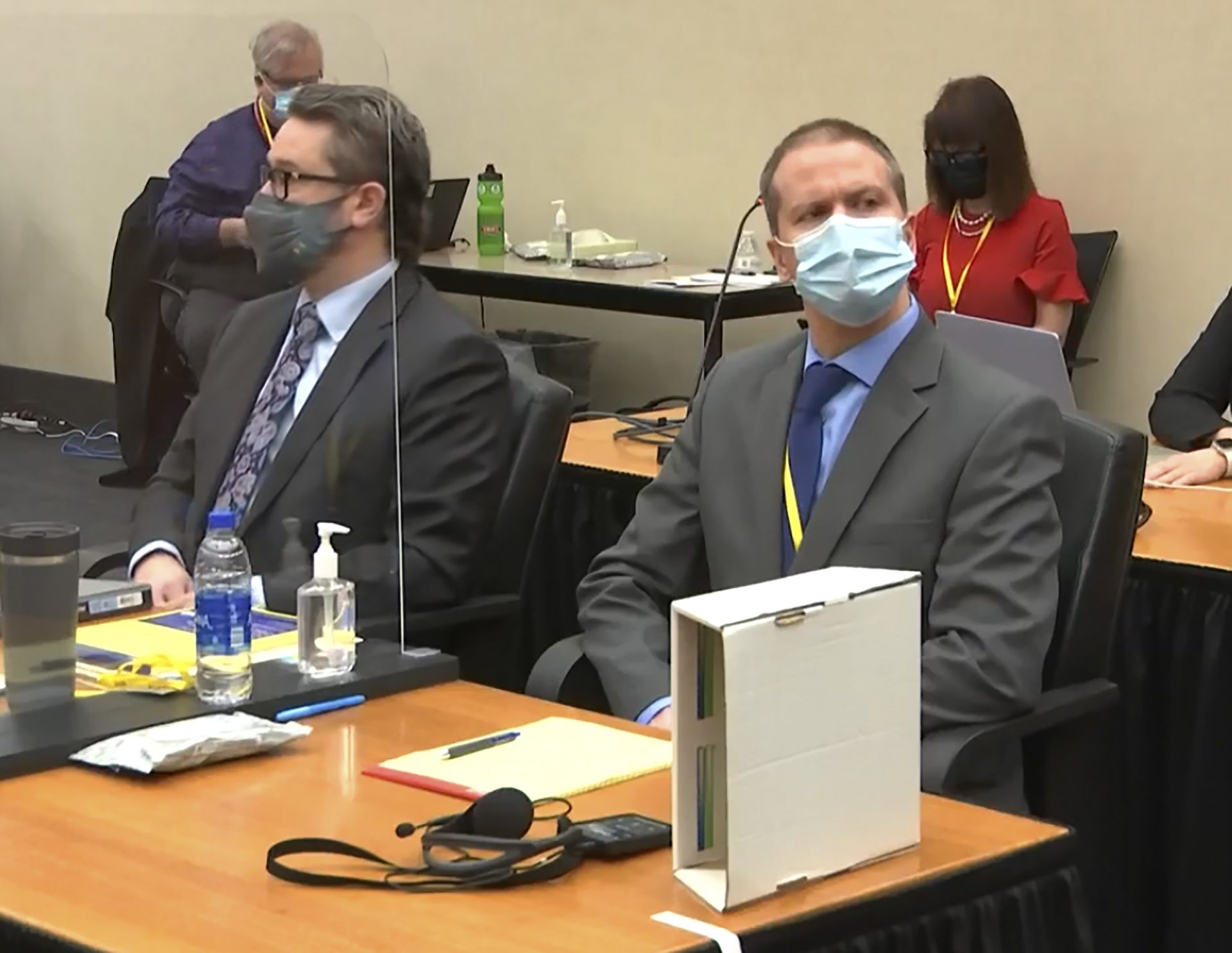 In this image from video, defense attorney Eric Nelson, left, and former Minneapolis police officer Derek Chauvin listen as Hennepin County Judge Peter Cahill presides over pre-trial motions prior to opening statements, Monday March 29, 2021, in the trial of Chauvin, in the May 25, 2020, death of George Floyd at the Hennepin County Courthouse in Minneapolis, Minn.