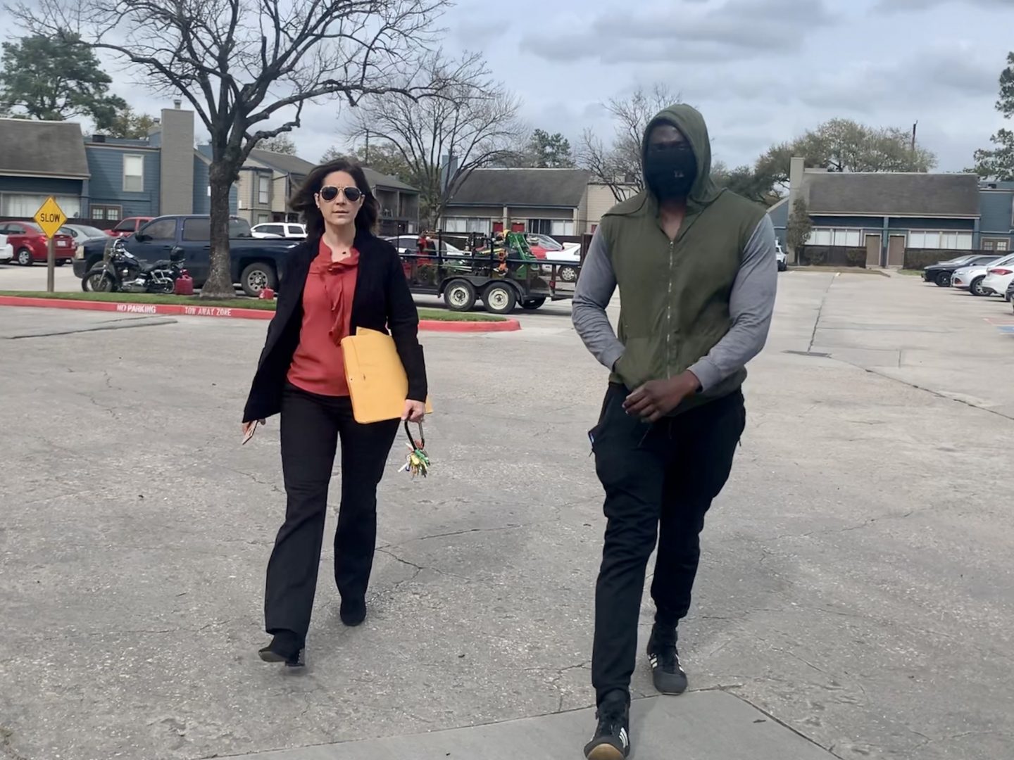 Landlord Stephanie Graves walks to the main office at one of her properties in Houston with a resident. She's going door to door offering to help residents apply for rental assistance money approved by Congress that's just starting to flow to landlords and tenants.