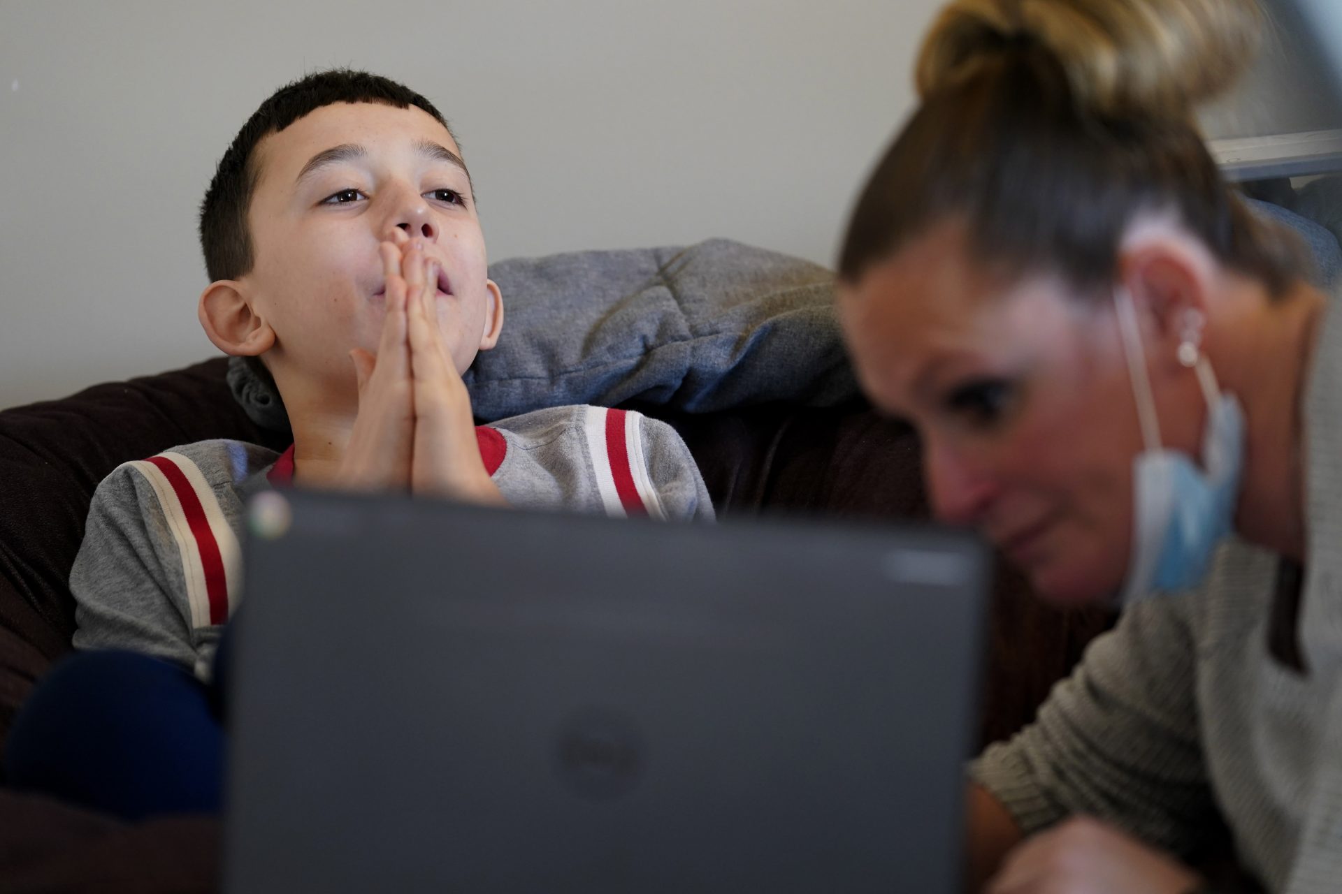 Paraprofessional Jessica Wein helps Josh Nazzaro with his school work while attending class virtually from his home in Wharton, N.J., Wednesday, Nov. 18, 2020.