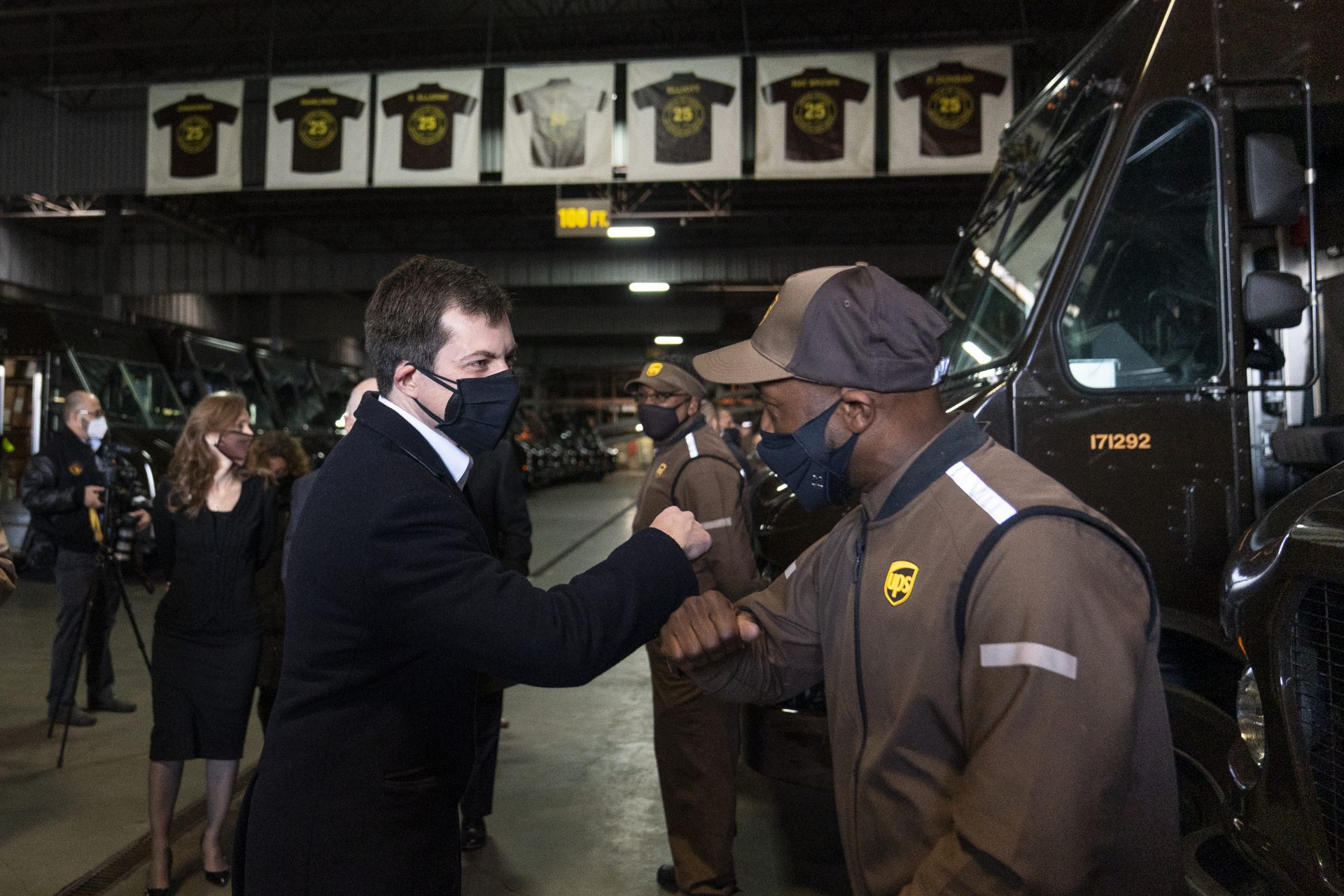 Transportation Secretary Pete Buttigieg greets UPS driver Ricardo Adams during a tour of a UPS Facility in Landover, Md., Monday, March 15, 2021.