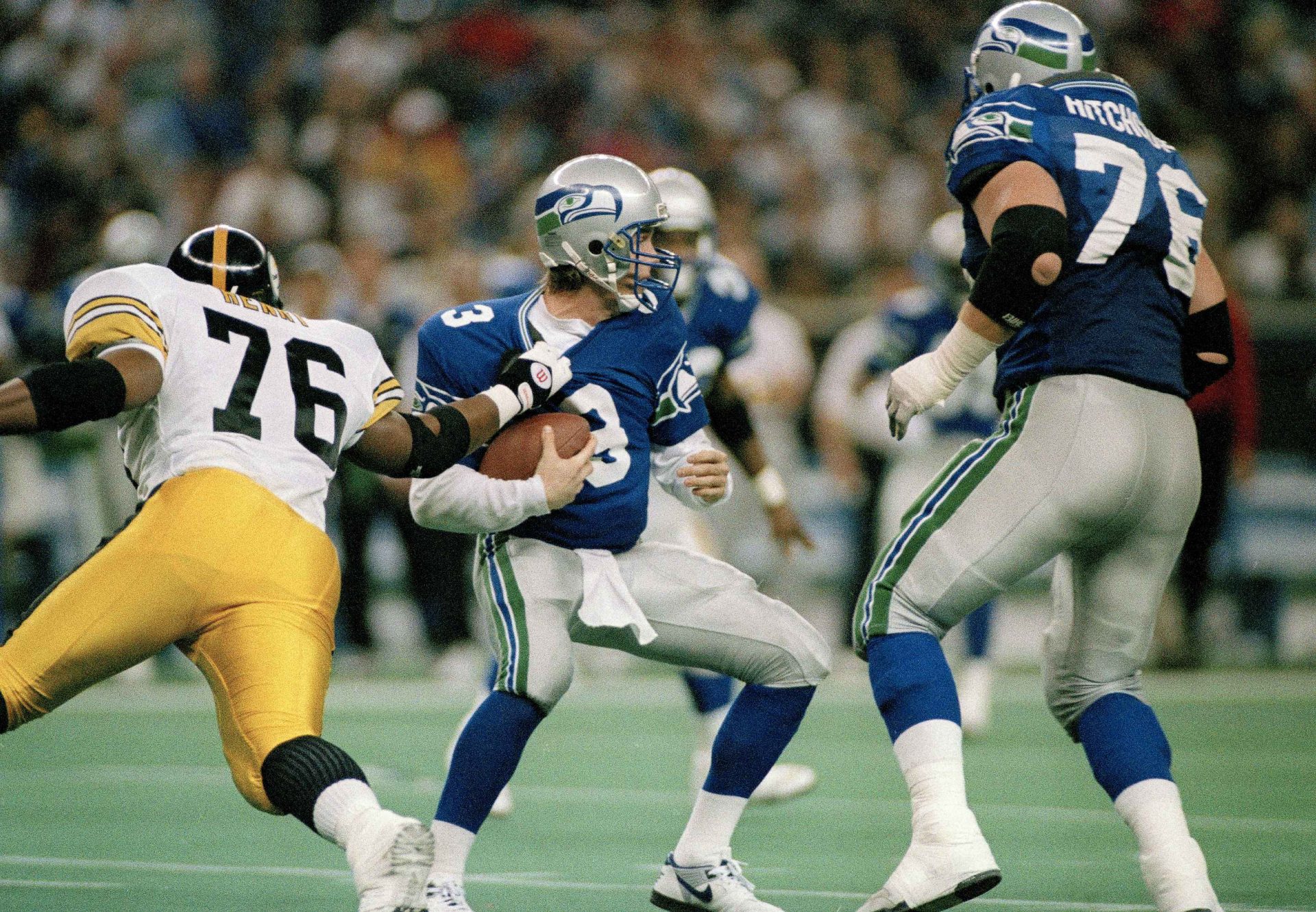 Seattle Seahawks quarterback, Rick Mirer (3) is sacked for a seven-yard-loss by Kevin Henry (76) of the Pittsburgh Steelers during the second quarter of their NFL game in Seattle, Wash., Sunday, Dec. 26, 1993. Dementia tests in the NFL concussion litigation allow doctors to use different baseline standards for Black and white retired players, making it more difficult for Blacks to show injury and qualify for awards, lawyers for two ex-players argued in court filings Tuesday, Aug. 25, 2020.