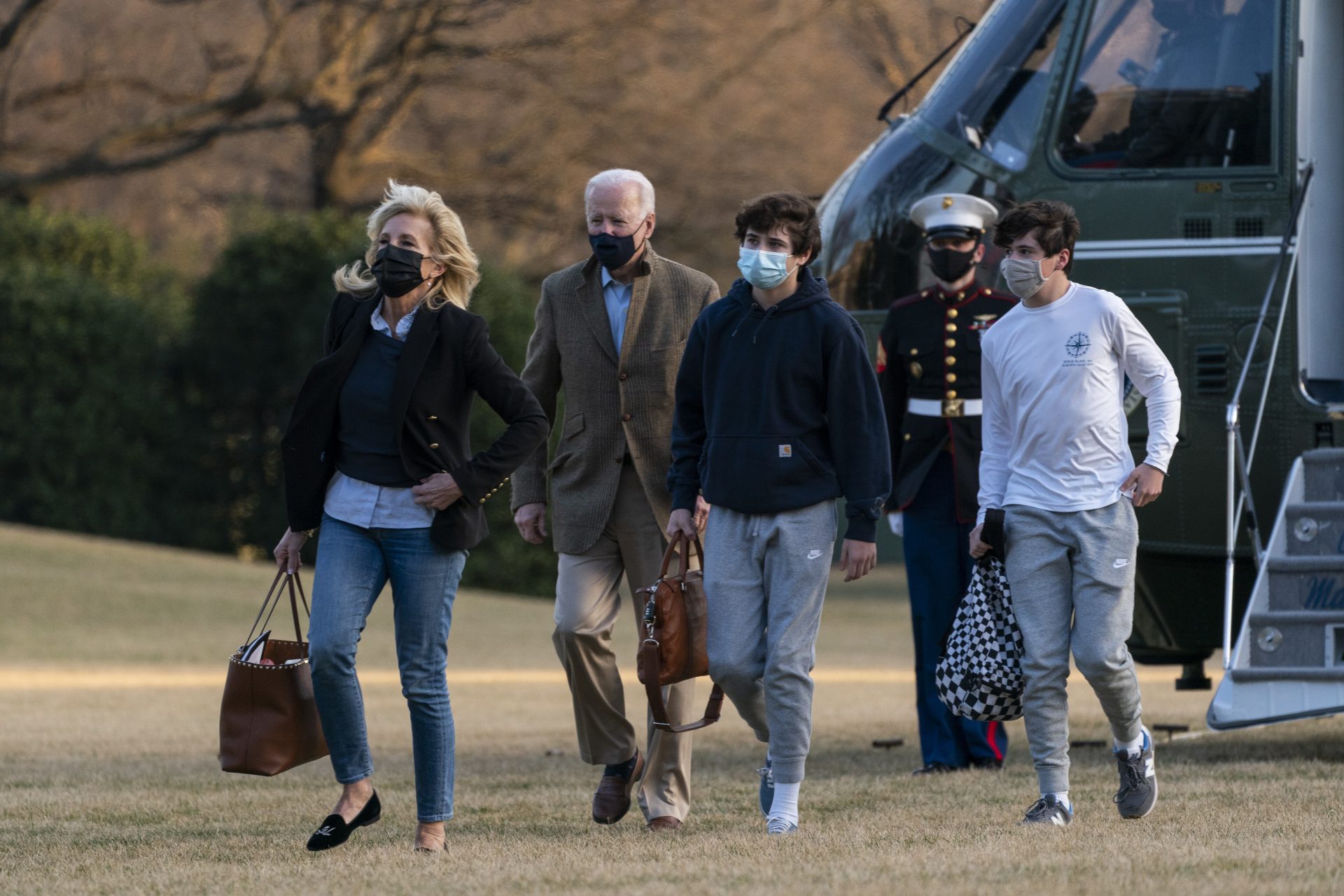 President Joe Biden and first lady Jill Biden with their grandson Hunter Biden, walk on the South Lawn upon arrival at the White House in Washington from a weekend trip to Wilmington, Del., Sunday, March 14, 2021.