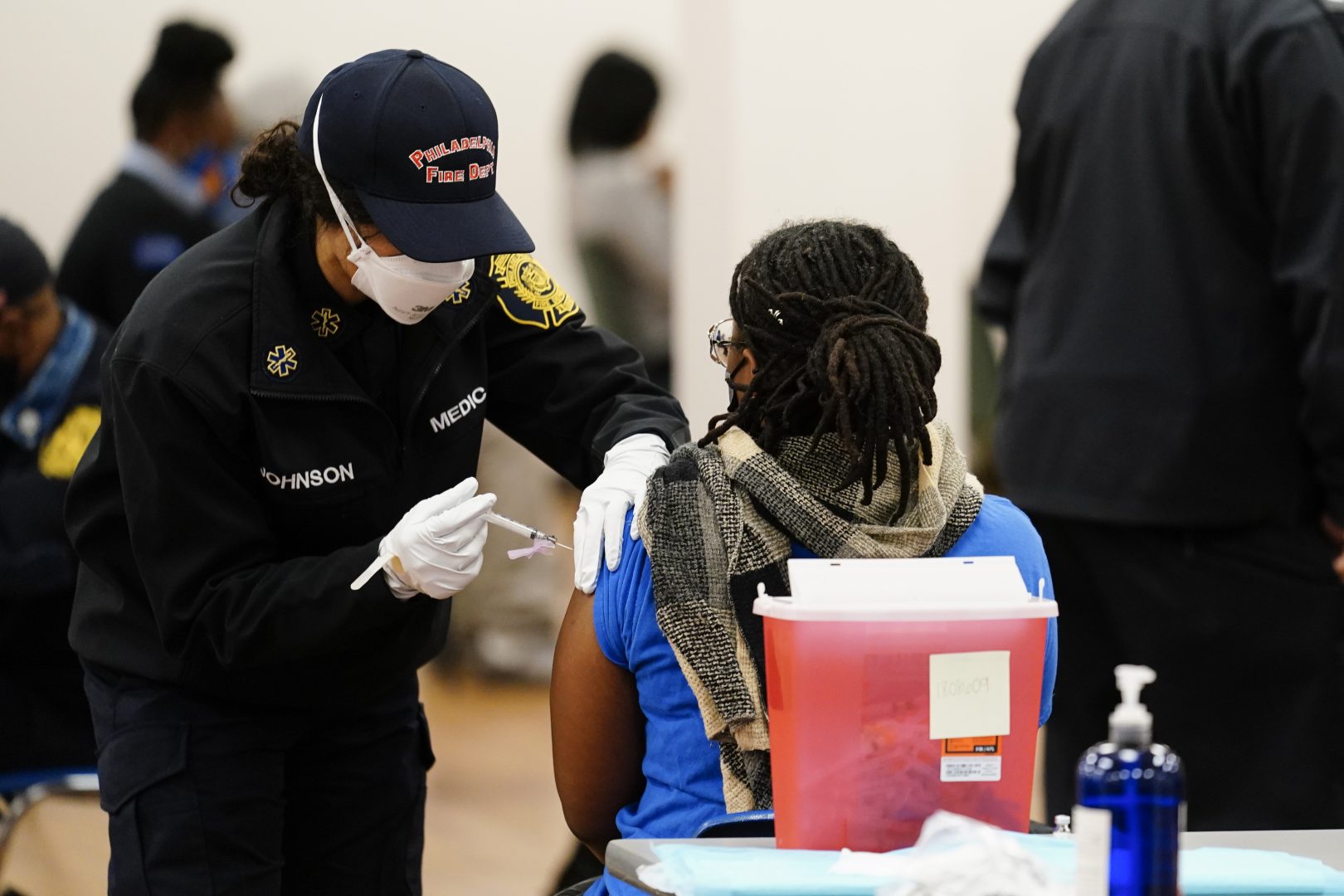A member of the Philadelphia Fire Department administers a COVID-19 vaccine at a vaccination site in Philadelphia, Monday, March 29, 2021. 