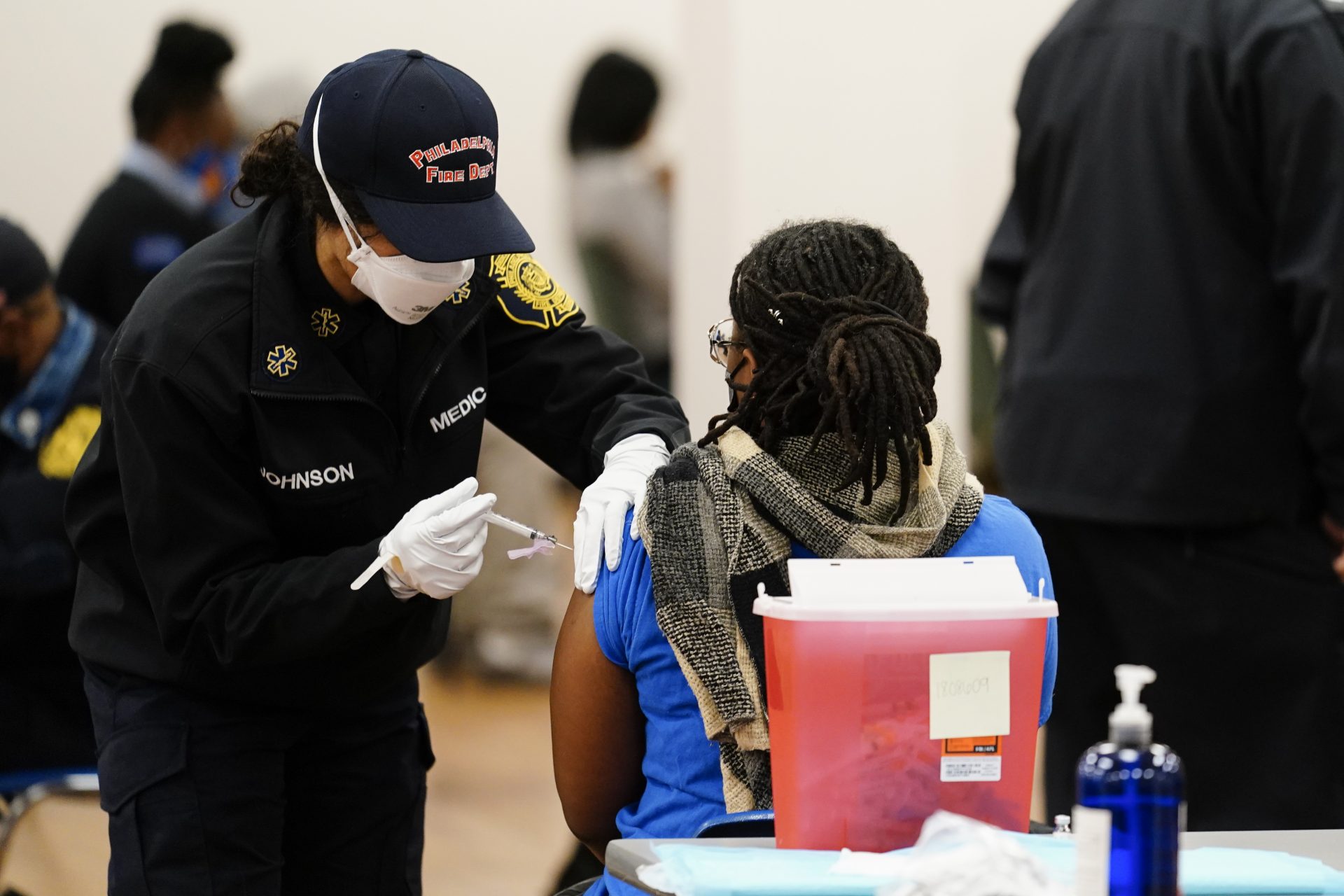 A member of the Philadelphia Fire Department administers a COVID-19 vaccine at a vaccination site in Philadelphia, Monday, March 29, 2021.