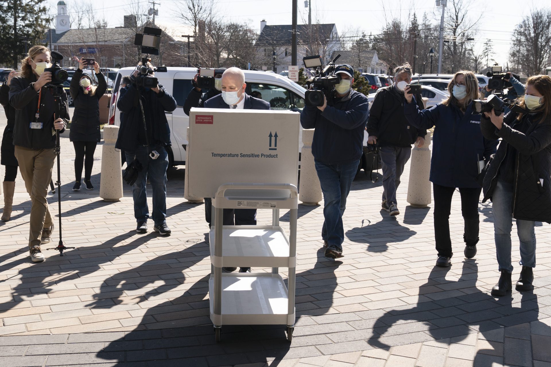 Pharmacist Jack Kann, center, delivers a case of the Johnson & Johnson COVID-19 vaccine at South Shore University Hospital, Wednesday, March 3, 2021, in Bay Shore, N.Y. Cities and states are rapidly expanding access to vaccines as the nation races to head off a resurgence in coronavirus infections and reopen schools and businesses battered by the pandemic.