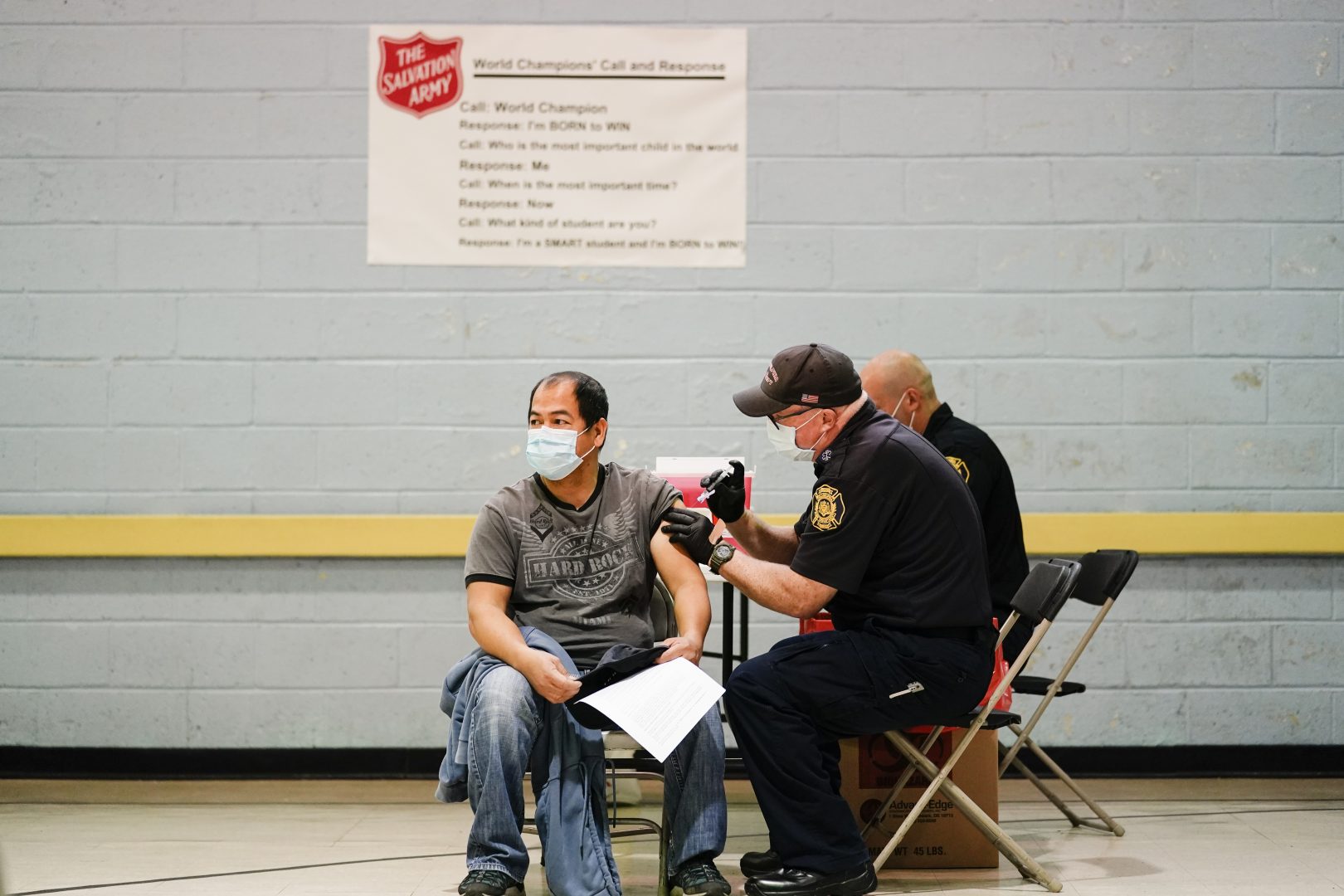 A member of the Philadelphia Fire Department administers the Johnson & Johnson COVID-19 vaccine to a person at a vaccination site setup at a Salvation Army location in Philadelphia, Friday, March 26, 2021.