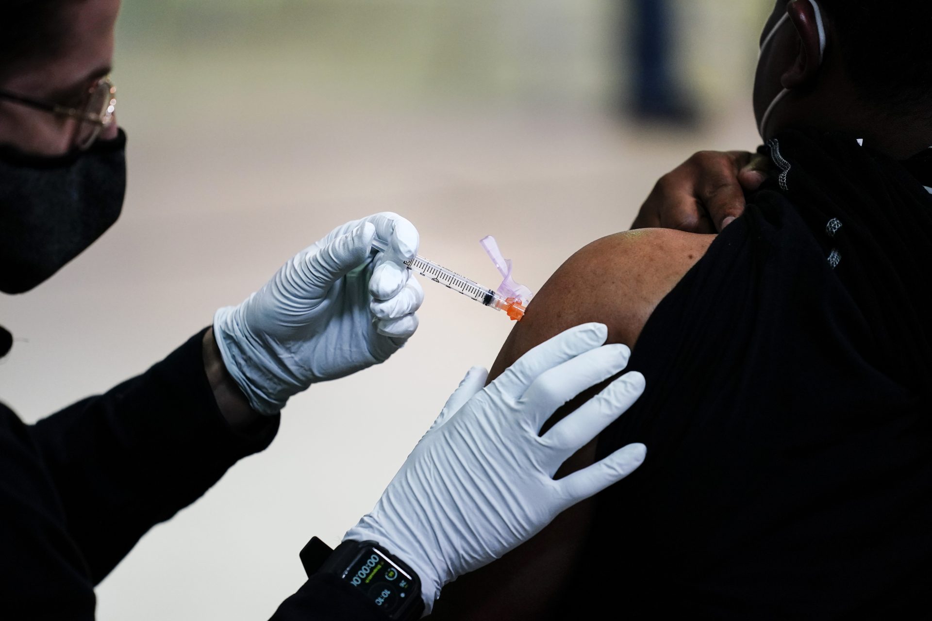 A member of the Philadelphia Fire Department administers the Johnson & Johnson COVID-19 vaccine to a person at a vaccination site at a Salvation Army location in Philadelphia on March 26, 2021.