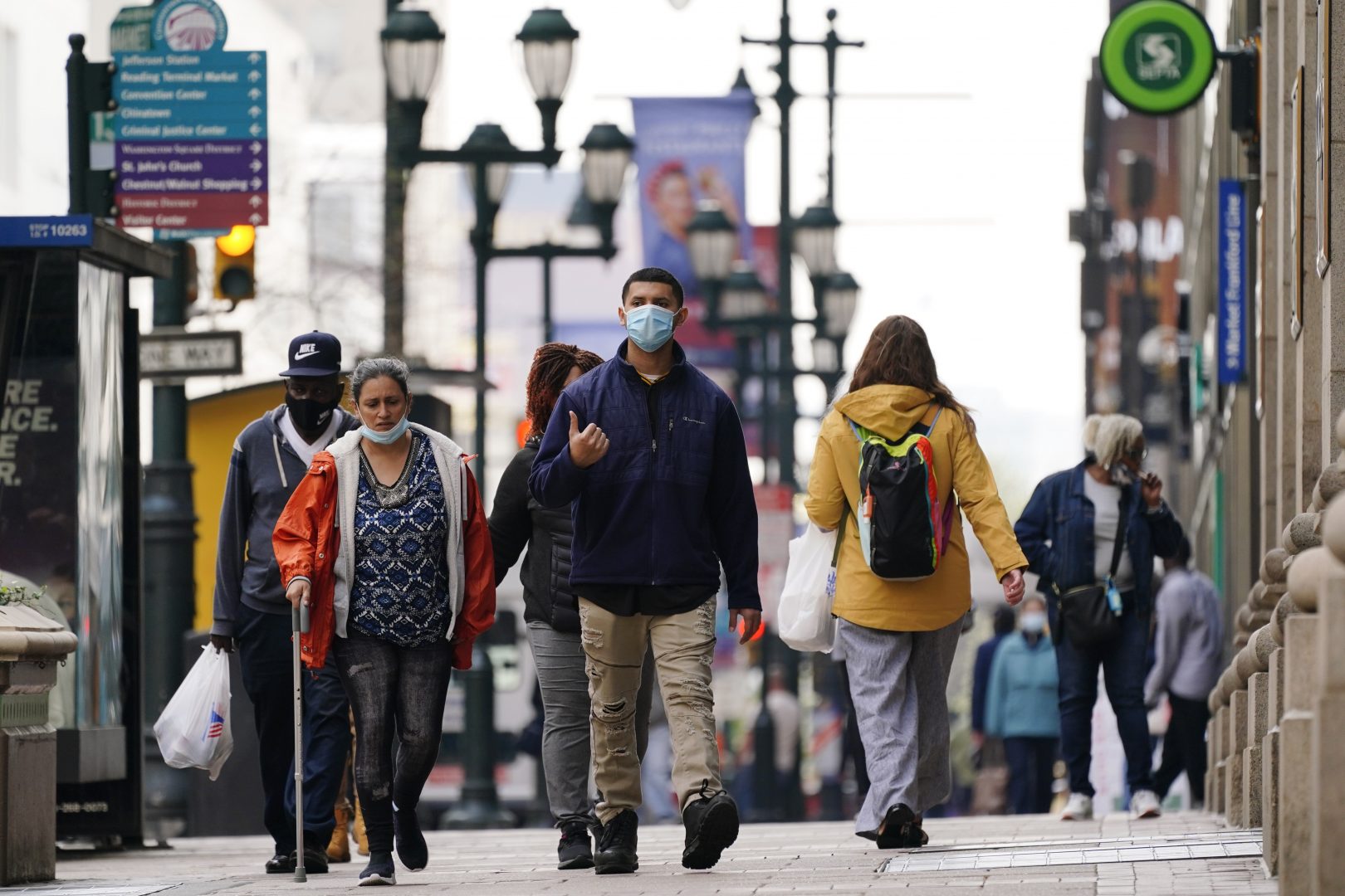 People walk along Market Street in Philadelphia, Wednesday, April 14, 2021. In Pennsylvania, redrawing the districts to correspond with population shifts identified by the 2020 census will have a particularly unpredictable effect on congressional districts, since the state is expected to lose a district.
