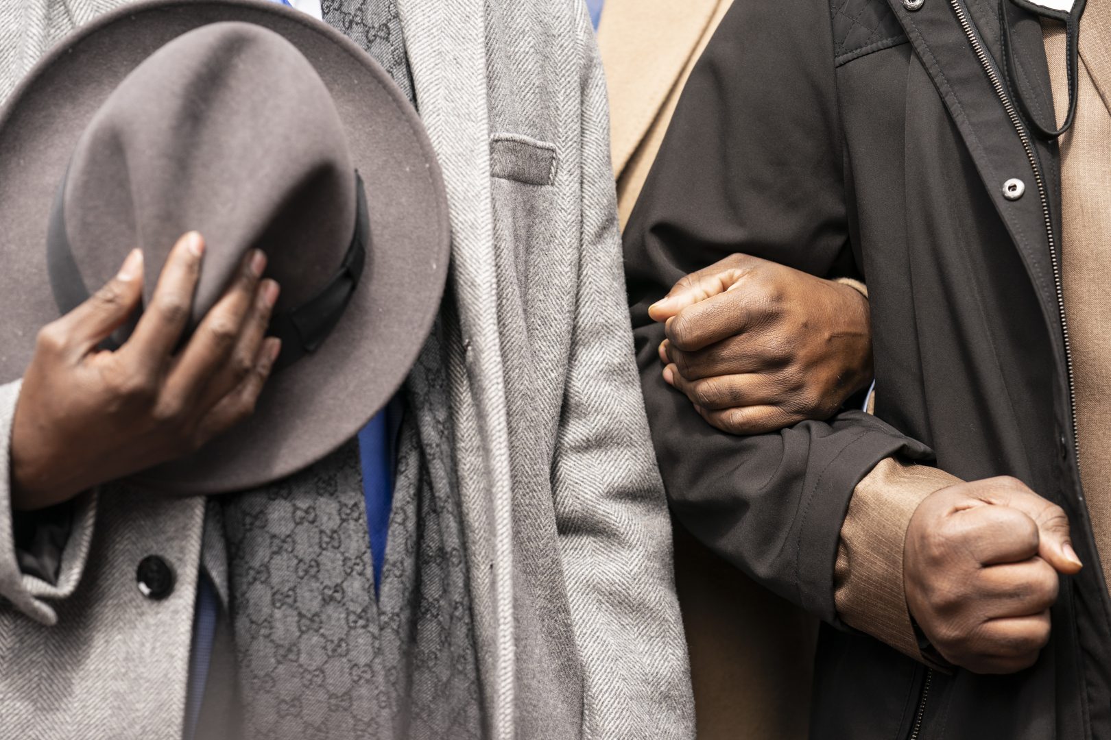 Philonise Floyd, left, and Rodney Floyd, right, brothers of George Floyd, lock arms during a prayer alongside attorney Ben Crump, left, during a news conference outside the Hennepin County Government Center before the murder trial against former Minneapolis police officer Derek Chauvin in the killing of George Floyd advances to jury deliberations, Monday, April 19, 2021, in Minneapolis.