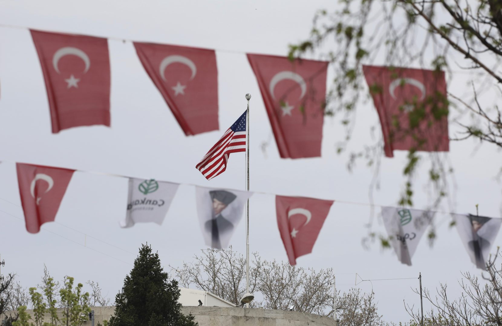 Turkish flags and banners depicting Mustafa Kemal Ataturk, the founder of modern Turkey, decorate a street outside the United States embassy in Ankara, Turkey, Sunday, April 25, 2021. Turkey's foreign ministry has summoned the U.S. Ambassador in Ankara to protest the U.S. decision to mark the deportation and killing of Armenians during the Ottoman Empire as 