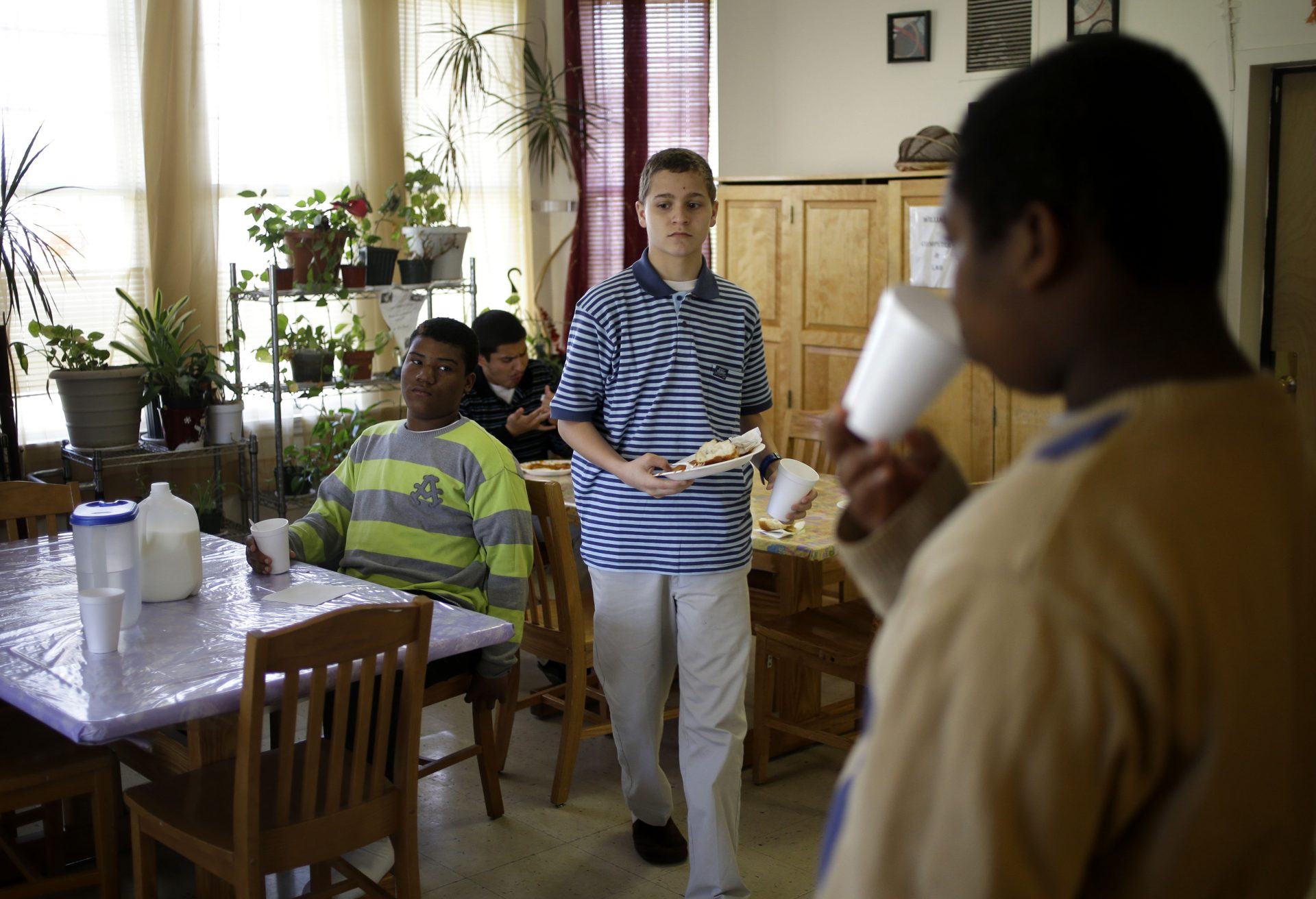 FILE PHOTO: In this Thursday, April 24, 2014 photo, residents of the WIlliams Cottage finish their lunch at The Children's Village campus in Dobbs Ferry, N.Y. A shift of mission by the company, which was founded in 1851, reflects a growing consensus within the child-welfare field that institutional settings for foster children - while sometimes necessary - should be used sparingly.