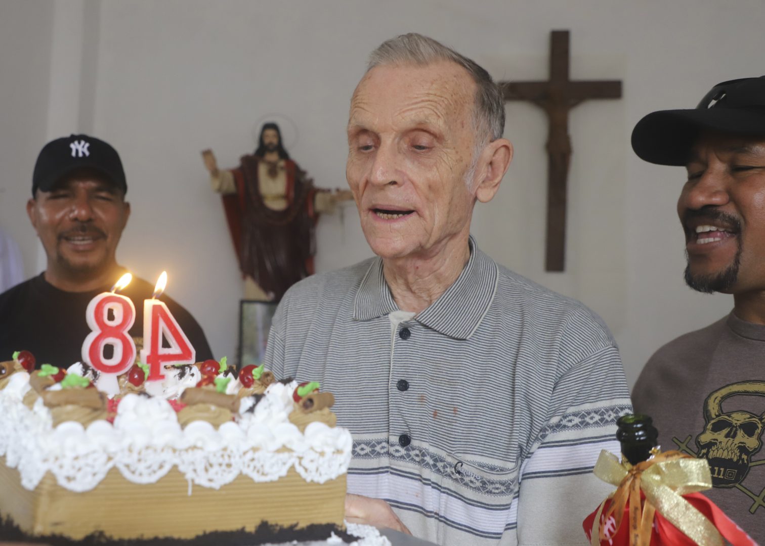 Now-defrocked Catholic priest Richard Daschbach, center, is presented a cake during his 84th birthday in Dili, East Timor, on Tuesday, Jan. 26, 2021. While he has his critics, Daschbach’s support appears deep and widespread, extending beyond Oecusse to the capital, Dili. It includes members of the political elite, including former President Xanana Gusmao  _ himself an independence hero _  who attended the opening of the trial in February, and this birthday celebration. 