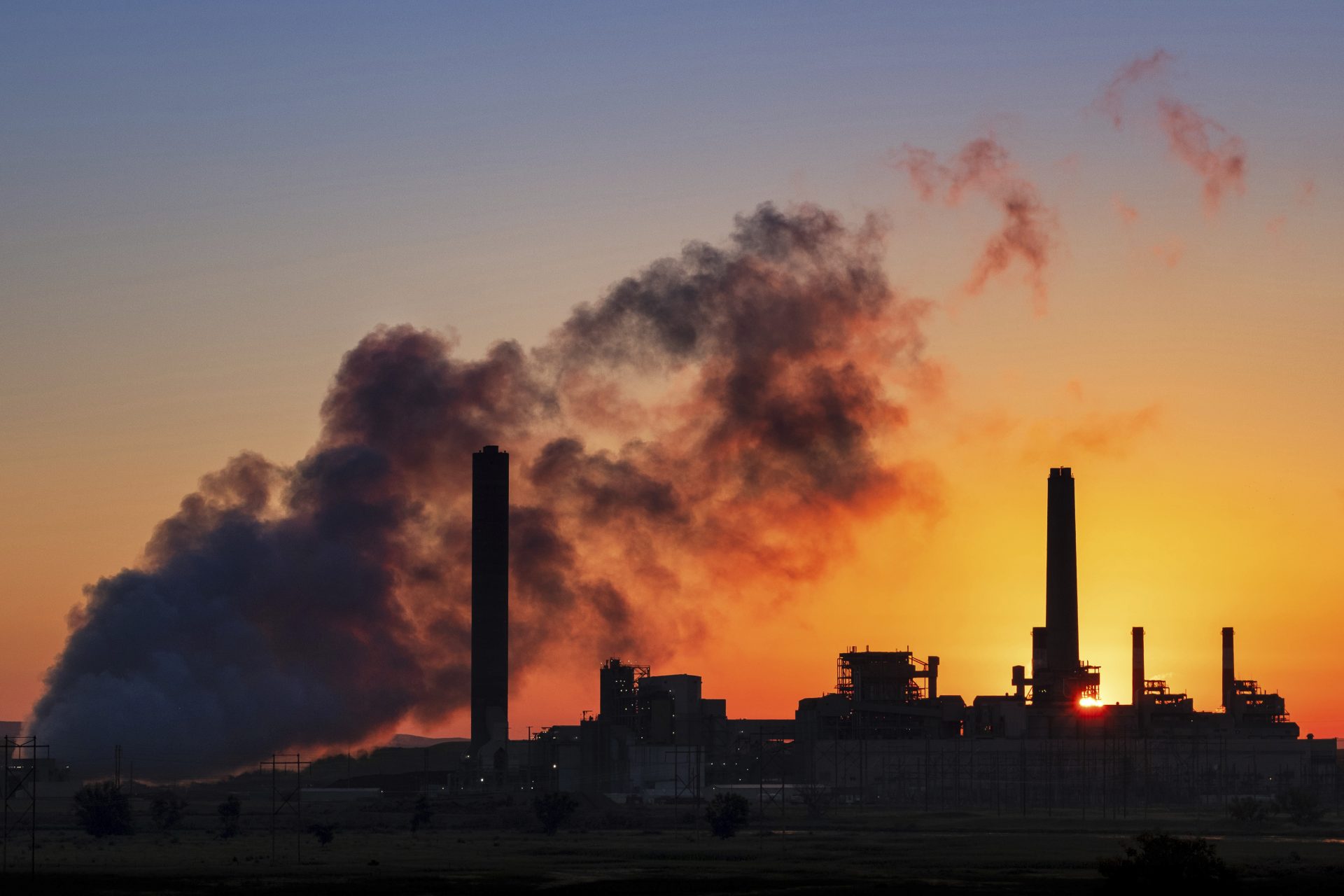 In this July 27, 2018, file photo, the Dave Johnson coal-fired power plant is silhouetted against the morning sun in Glenrock, Wyo. More than 300 businesses and investors are calling on the Biden administration to set an ambitious climate change goal that would cut U.S. greenhouse gas emissions by at least 50% below 2005 levels by 2030.