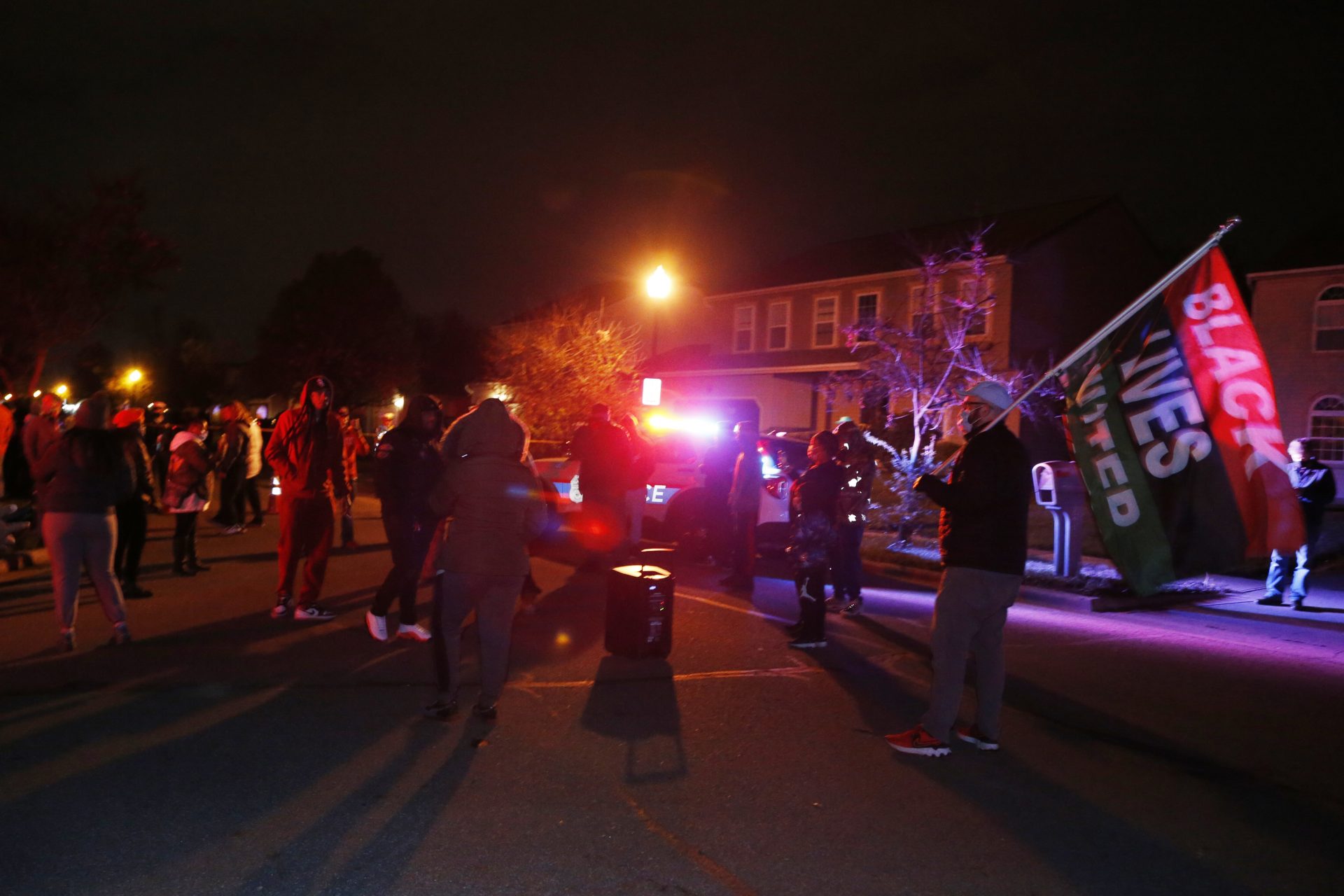 A crowd gathers to protest in the neighborhood where a Columbus police officer fatally shot a teenage girl, Tuesday, April 20, 2021, in Columbus, Ohio.
