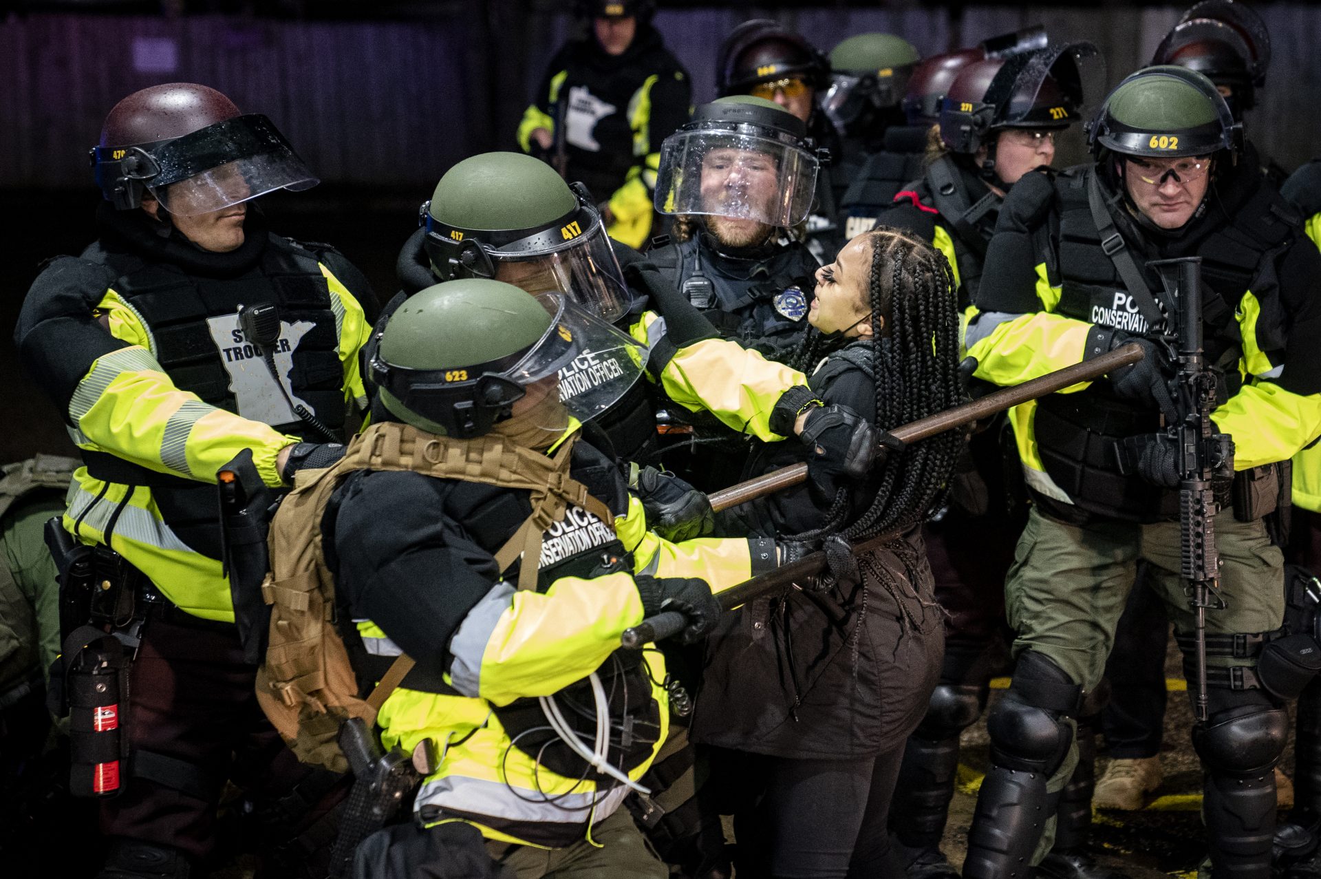 A demonstrator is arrested by police for violating curfew and an order to disperse during a protest against the police shooting of Daunte Wright, Monday, April 12, 2021, in Brooklyn Center, Minn.