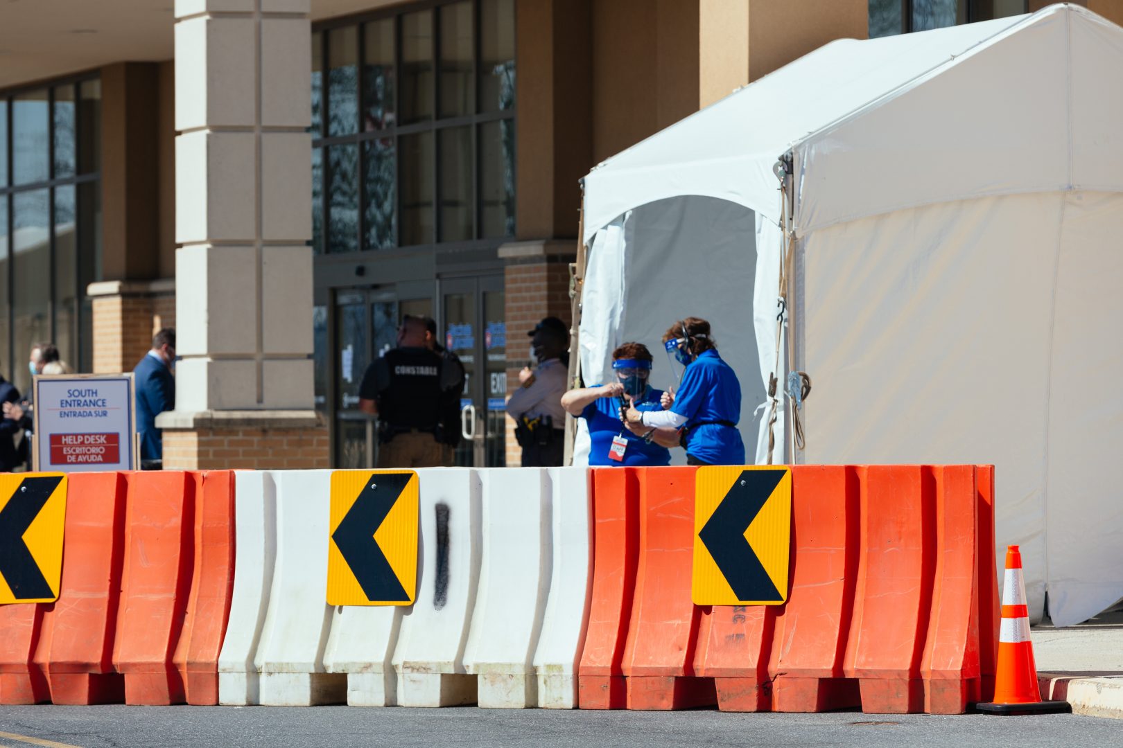 Health care workers stand outside a COVID-19 vaccination site at the former Bon-Ton department store at Park City Center in Lancaster on March 10, 2021.