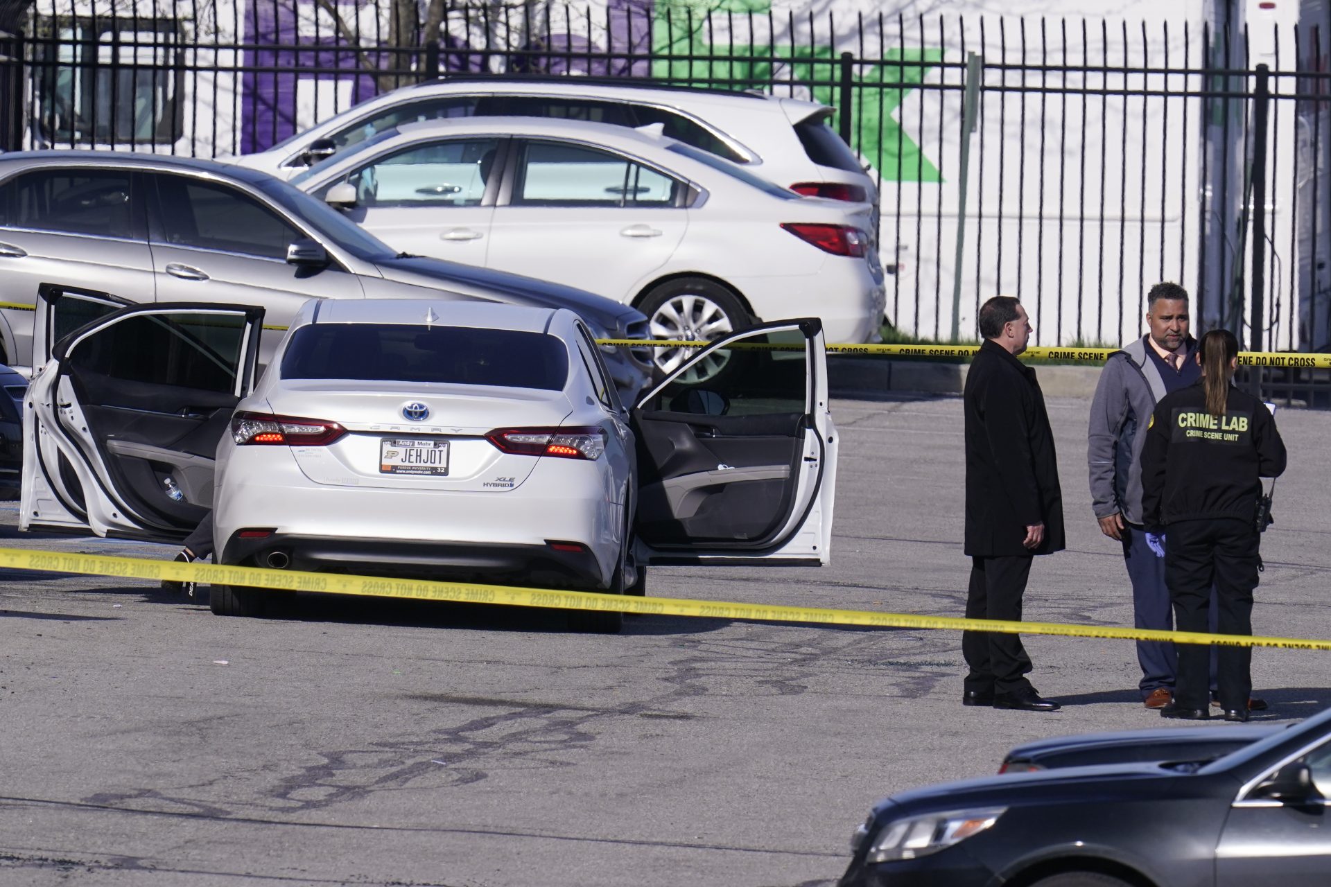Authorities confer at the scene where multiple people were shot at the FedEx Ground facility early Friday morning, April 16, 2021, in Indianapolis.