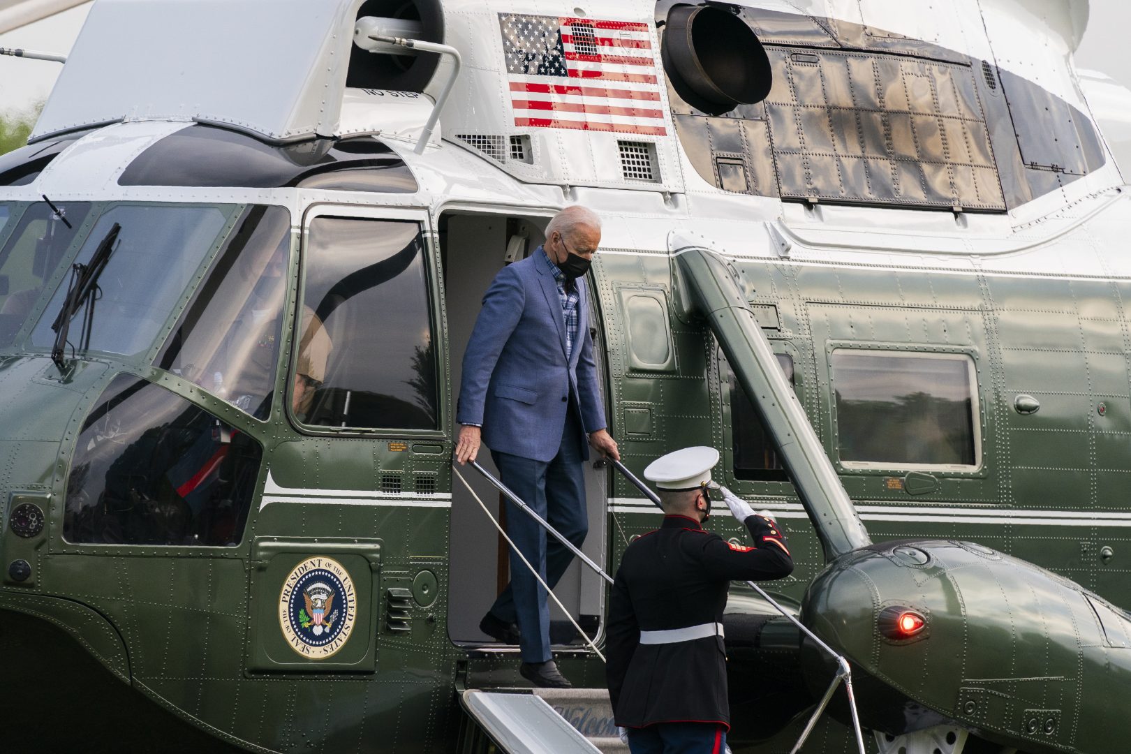A Marine Corps honor guard salutes as President Joe Biden disembarks from Marine One on the Ellipse near the White House after spending the weekend in Wilmington, Del., Sunday, April 25, 2021, in Washington. 