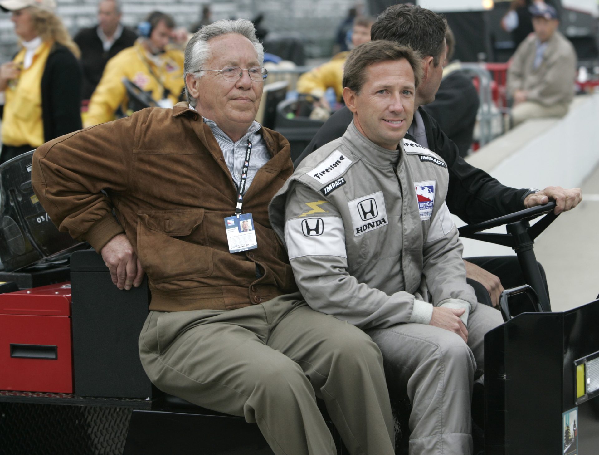In this May 14, 2008, file photo, John Andretti, right, rides out to the pit area with his father, Aldo Andretti, for practice for the Indianapolis 500 auto race at Indianapolis Motor Speedway in Indianapolis.