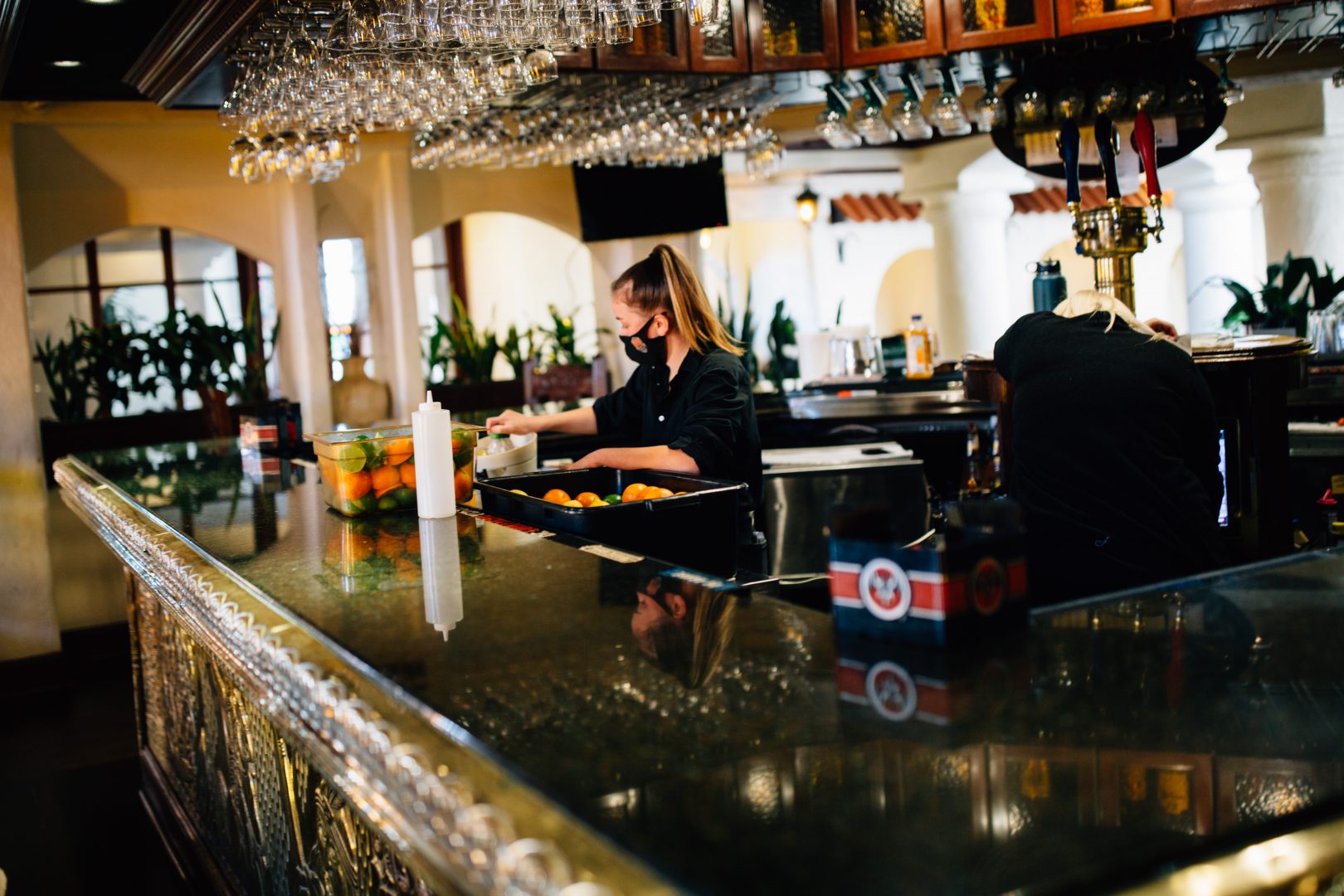 A bartender works at El Serrano in Lancaster on April 2, 2021.