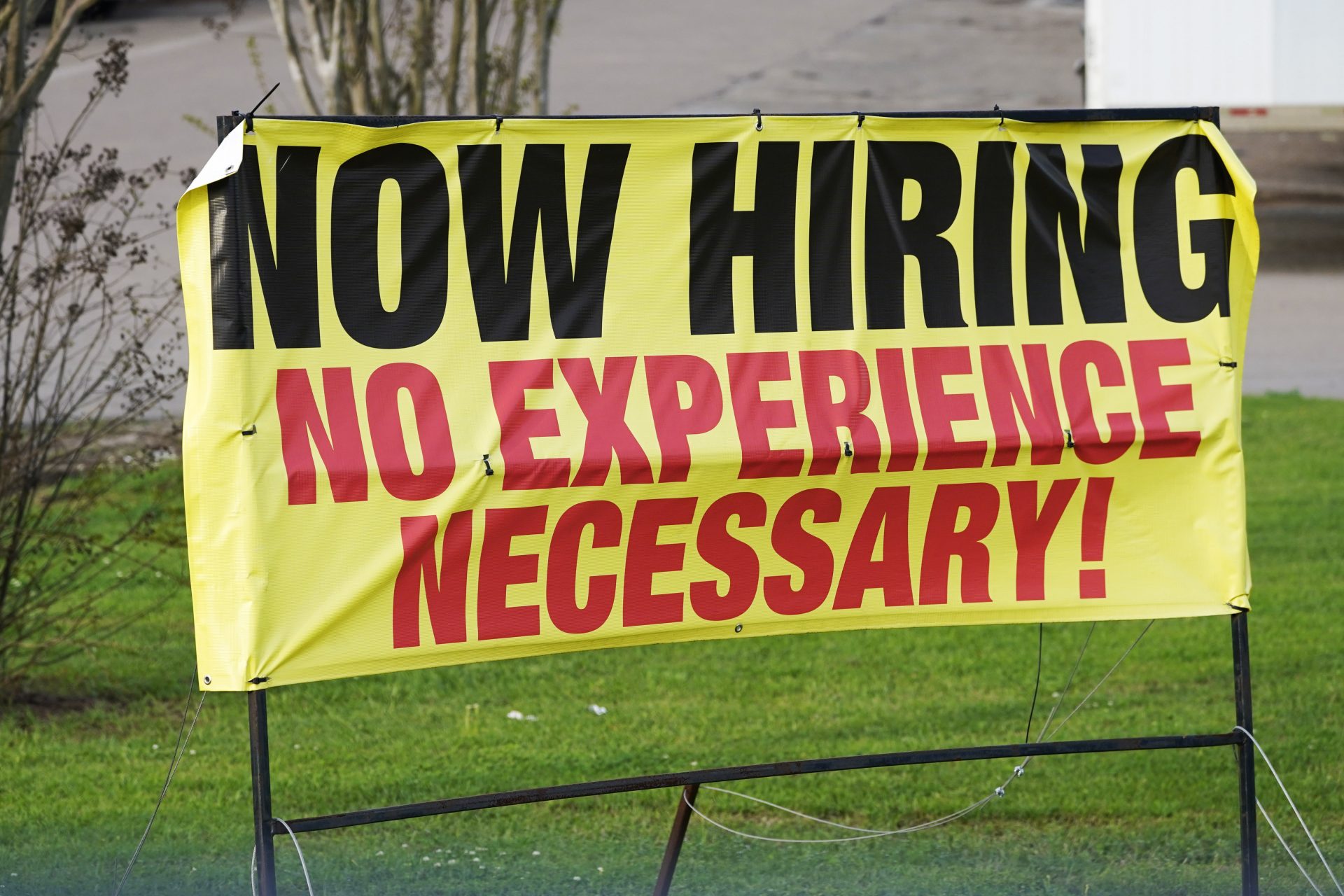 A roadside banner beckons potential employees outside Channel Control Merchants LLC, an extreme value retailer and exporter of brand sensitive secondary market inventories, in Hattiesburg, Miss., March 27, 2021.