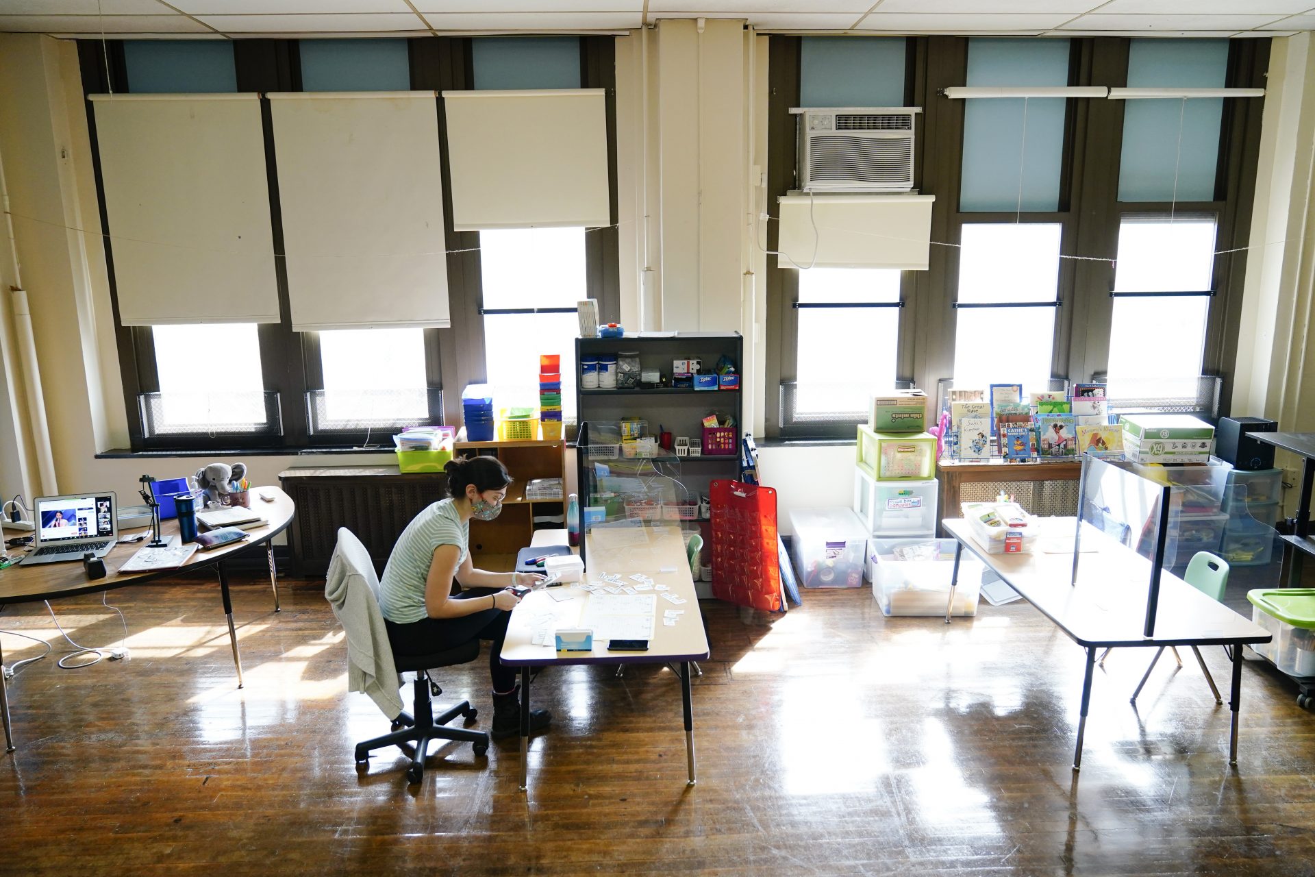 In this Friday, March 19, 2021, file photo, teacher Laura Bonanni prepares her kindergarten classroom for planned in-person learning at Nebinger Elementary School in Philadelphia.