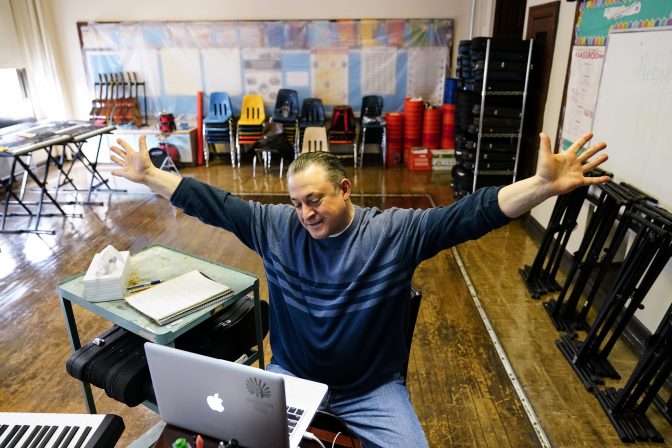 Music teacher Marc Dulberg teaches his students virtually ahead of planned in-person learning at Nebinger Elementary School in Philadelphia, Friday, March 19, 2021.